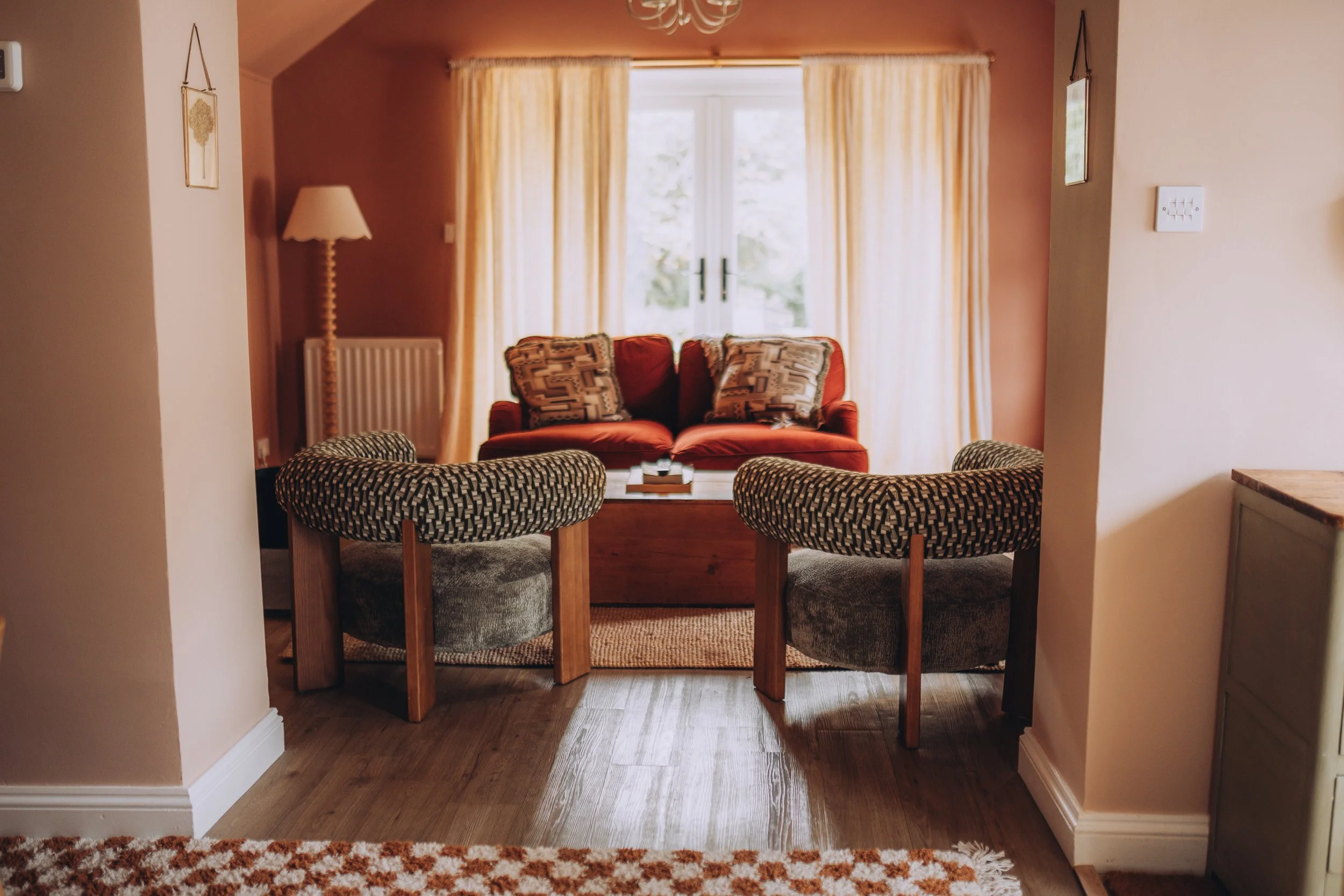 Sitting room with patterned armchairs at Church Farm Estate