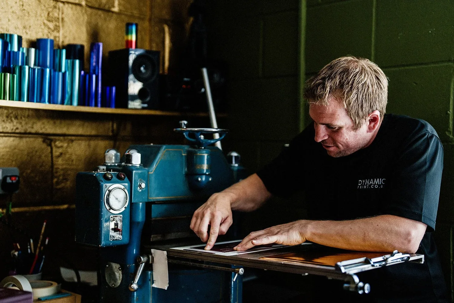 A man is seen hot-foiling at Dynamic Print, a print facility in Norwich.