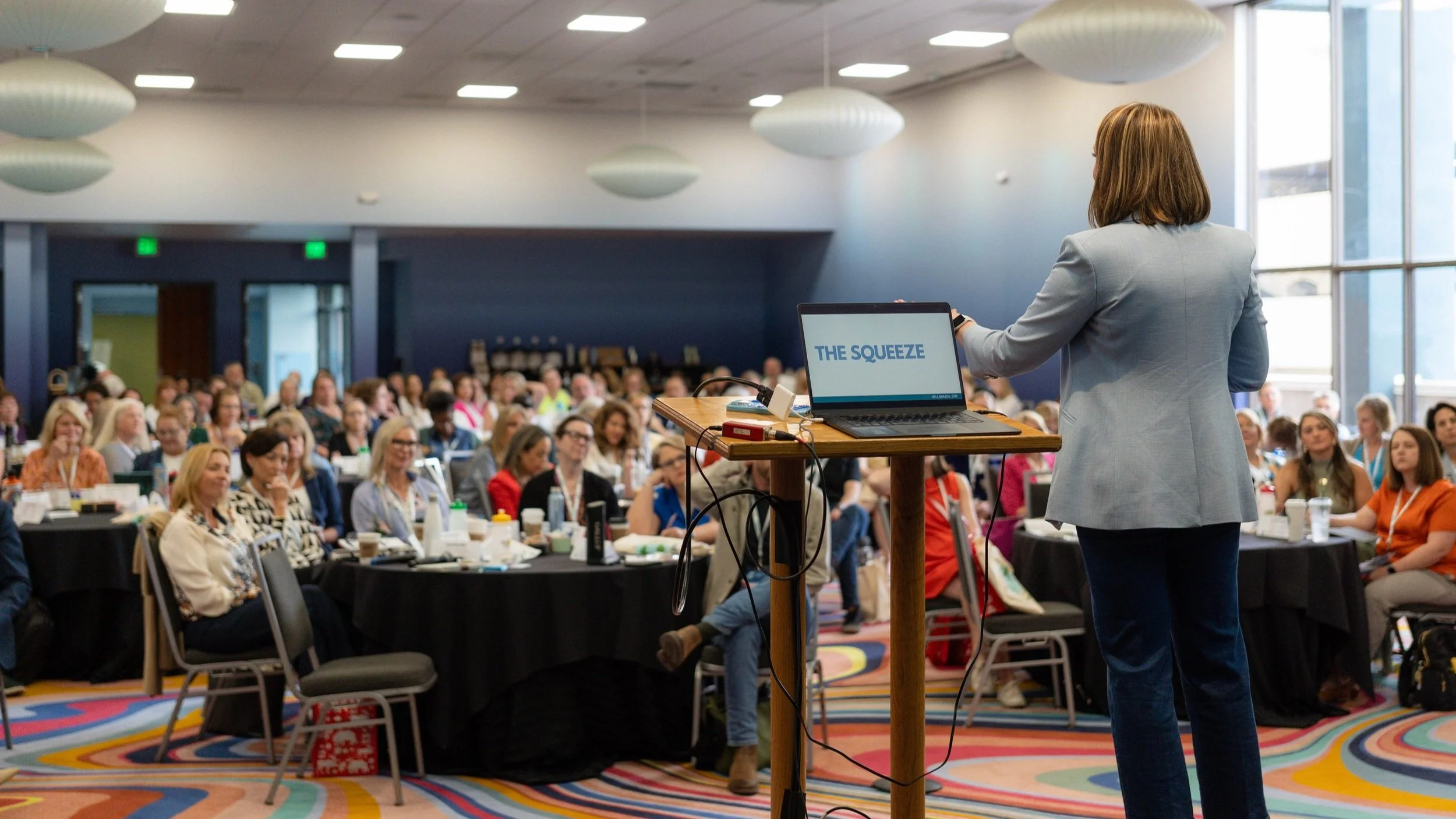 Speaker on stage in professional setting