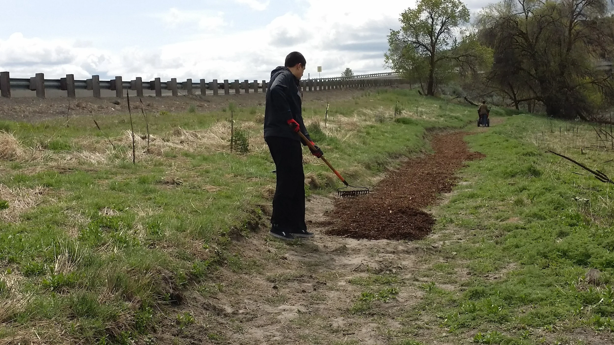 Student volunteers spreading bark on new Ken Hay trail.jpg