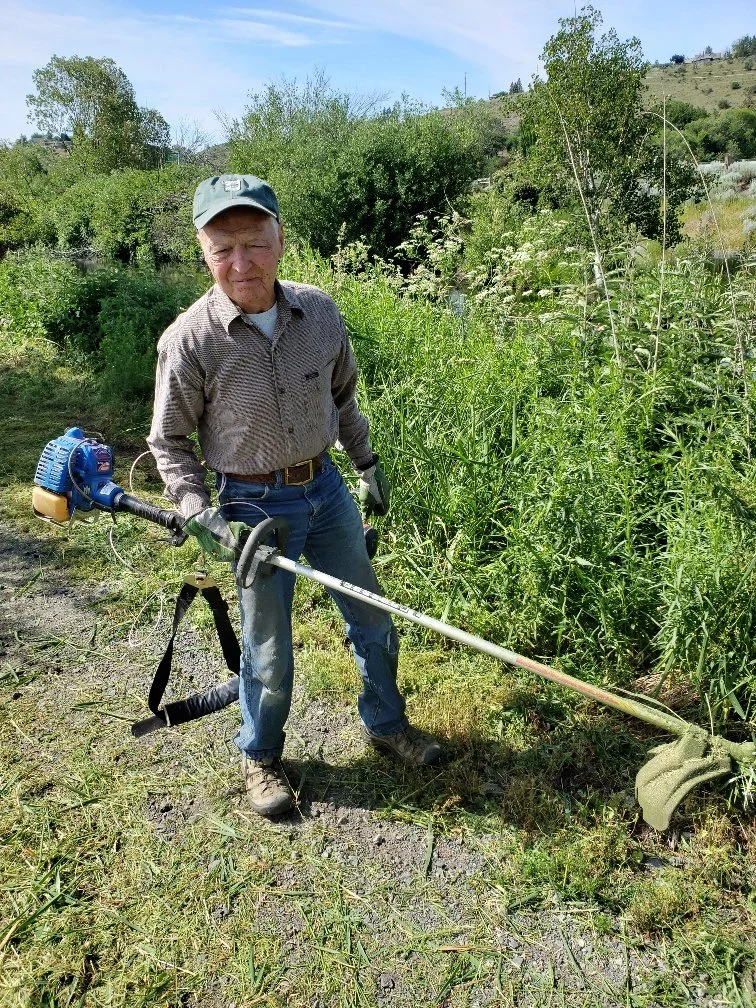 Dr. Glenn Gailis volunteering to control weeds.jpg