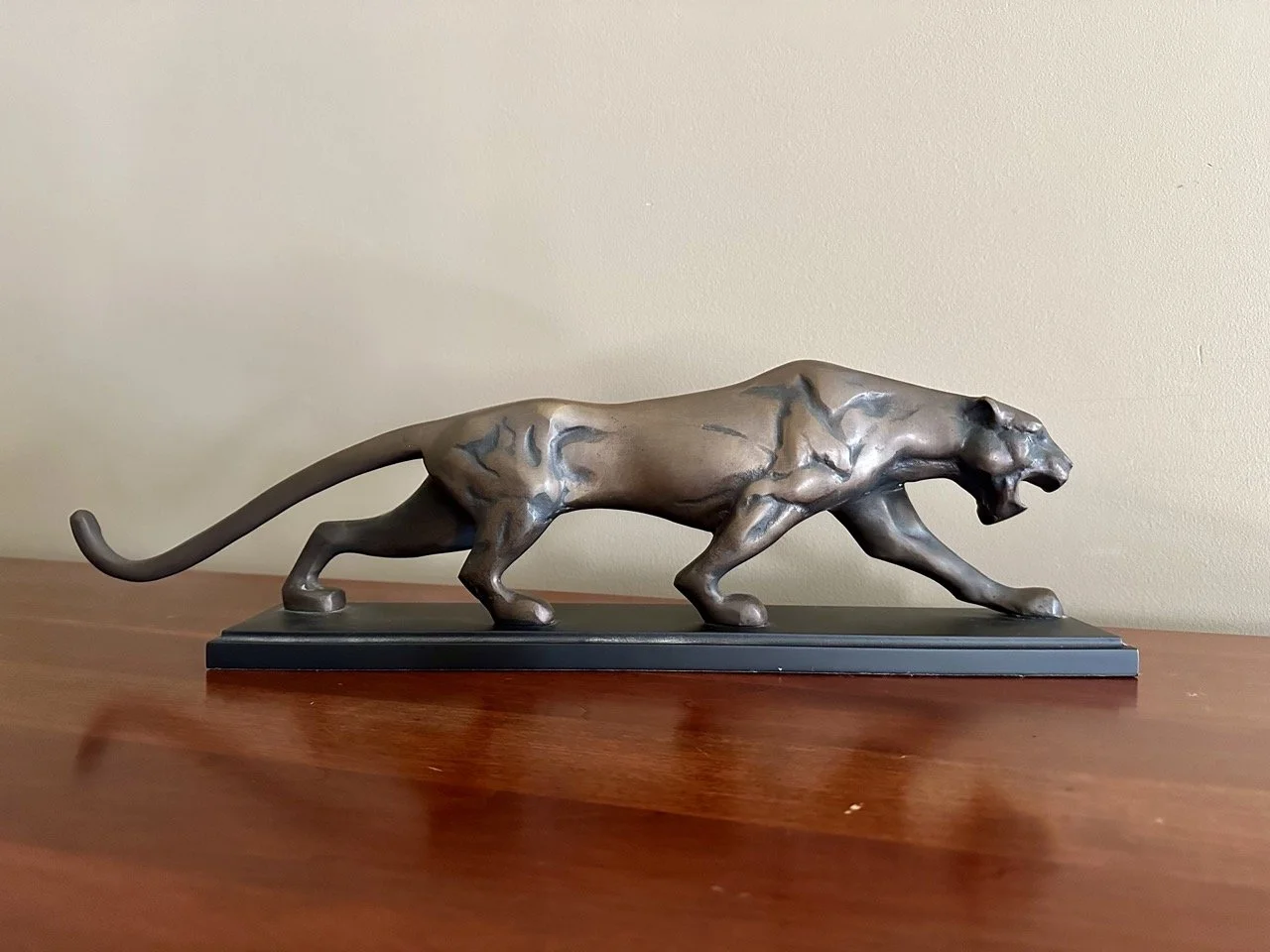 $30 • Modern Metal Panther Sculpture • Sleek minimalist panther sculpture with a long, low silhouette and metallic finish on a black base, clean contemporary decor piece in excellent condition • Dimensions: 10.5” L x 6.75” H x 4” W
