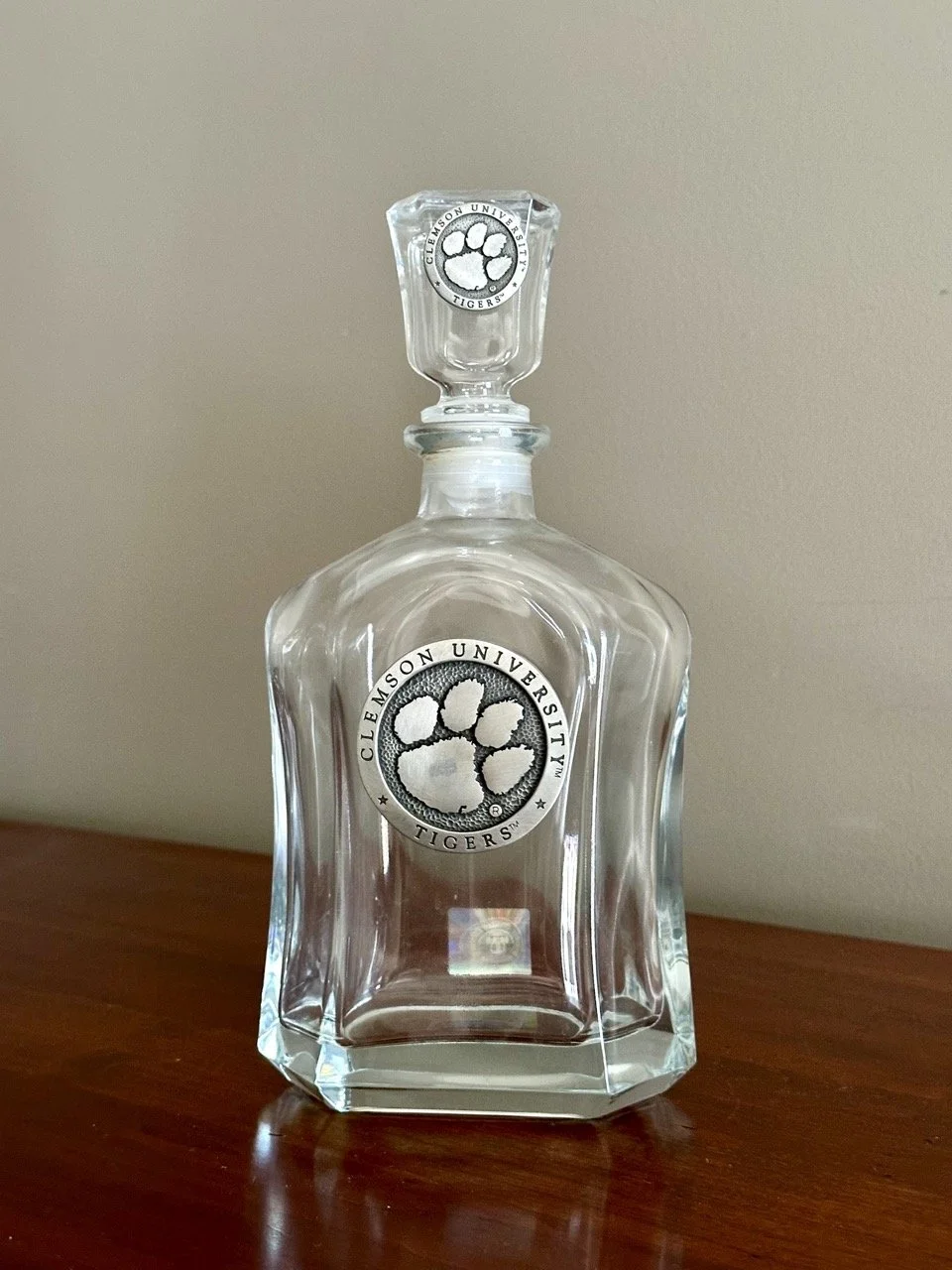 $30 • Clemson University Glass Decanter with Pewter Medallions and Stopper • Clear glass decanter featuring applied fine pewter Clemson Tigers medallions by Heritage Metalworks and matching stopper, licensed collectible piece ideal for bar display or