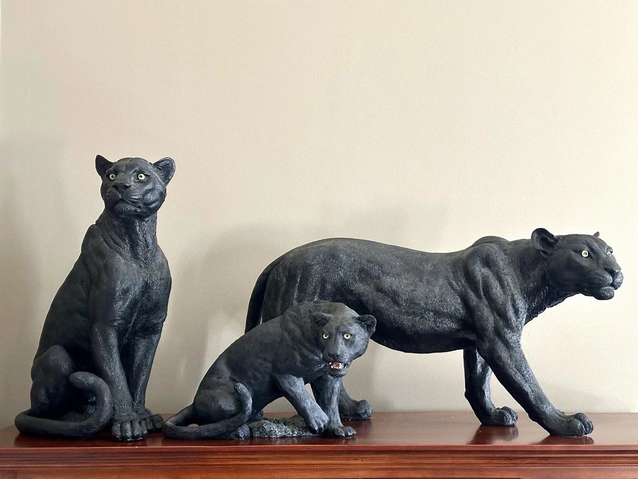 $95 • Large Black Panther Statue Set (3-Piece) • Set of three black panther sculptures with strong visual presence, including two larger figures and one smaller (marked Living Stone, San Diego), all in good condition and displayed well together • Dim