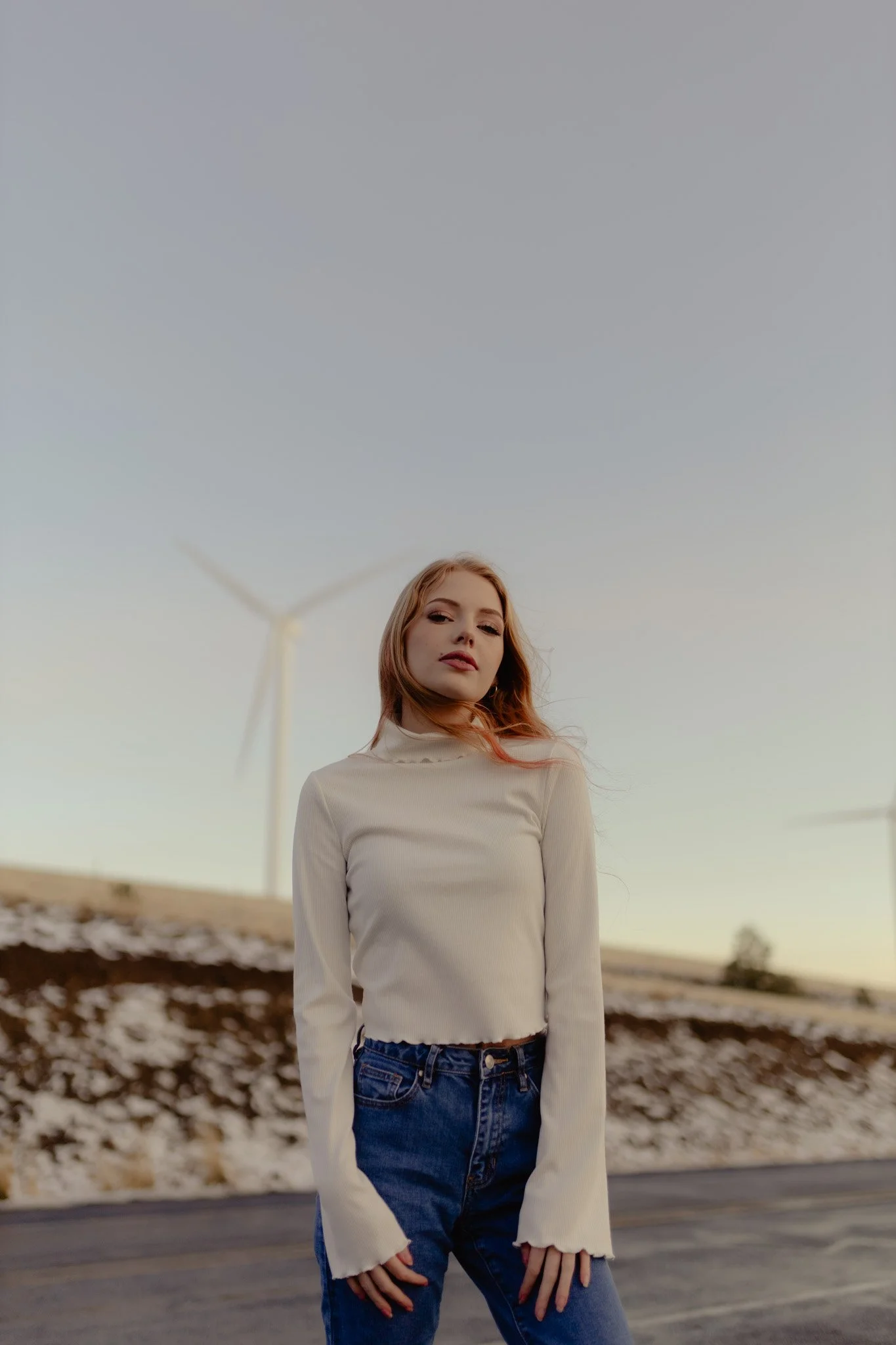 model posing in front of windmills in the winter in Ellensburg, Washington.