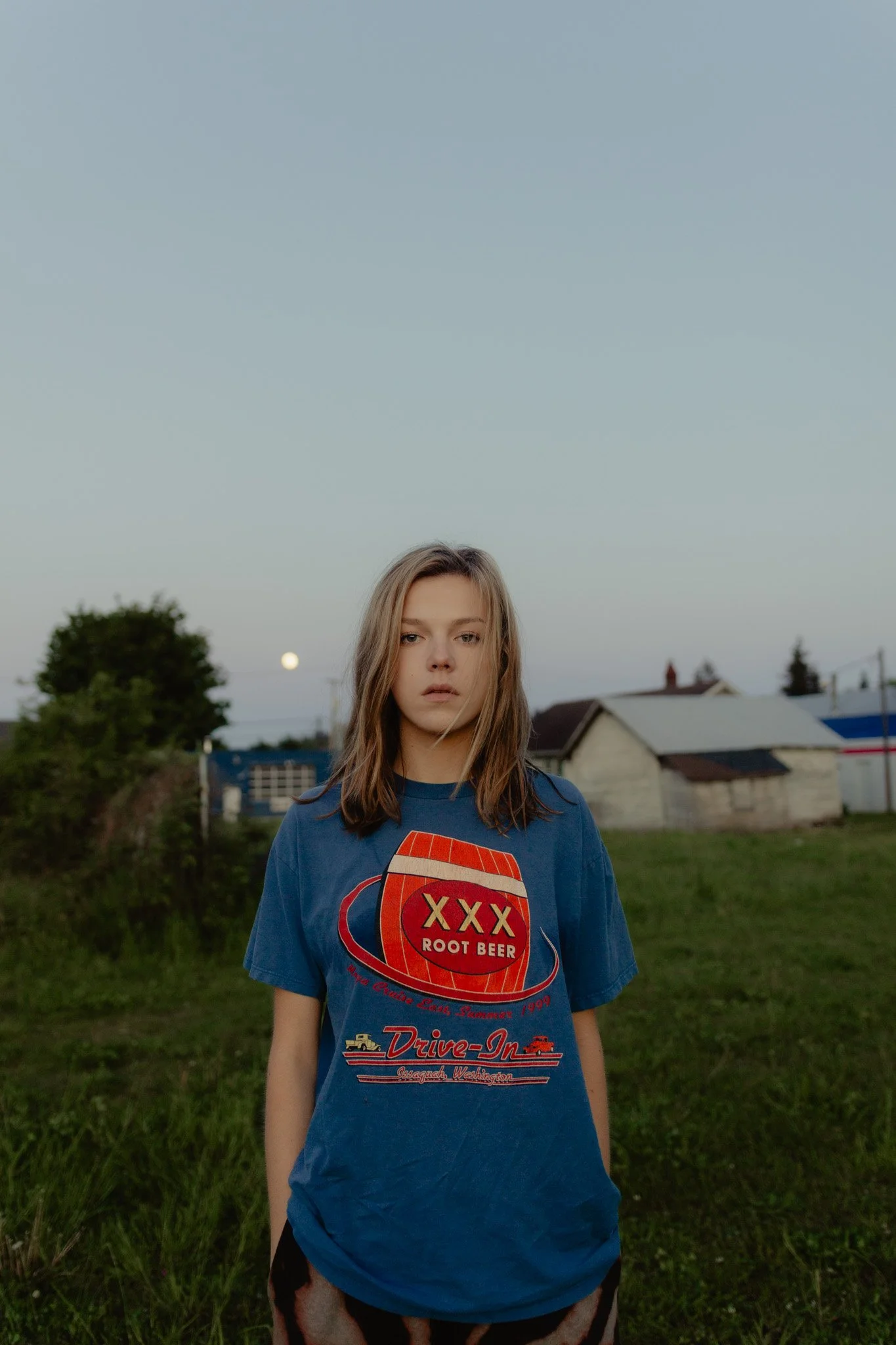 Model posing in a field at blue hour in Shelton, Washington.