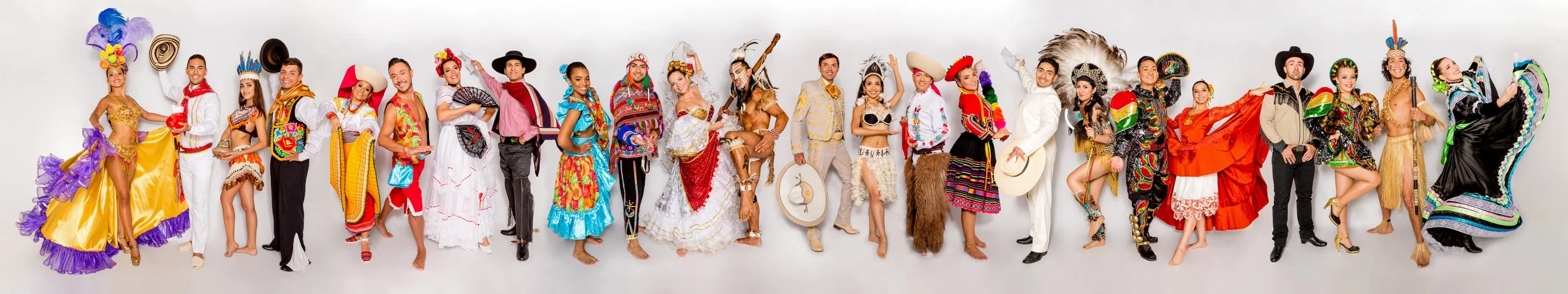 Group of people in colorful traditional Mexican costumes and attire, celebrating in a festive atmosphere.