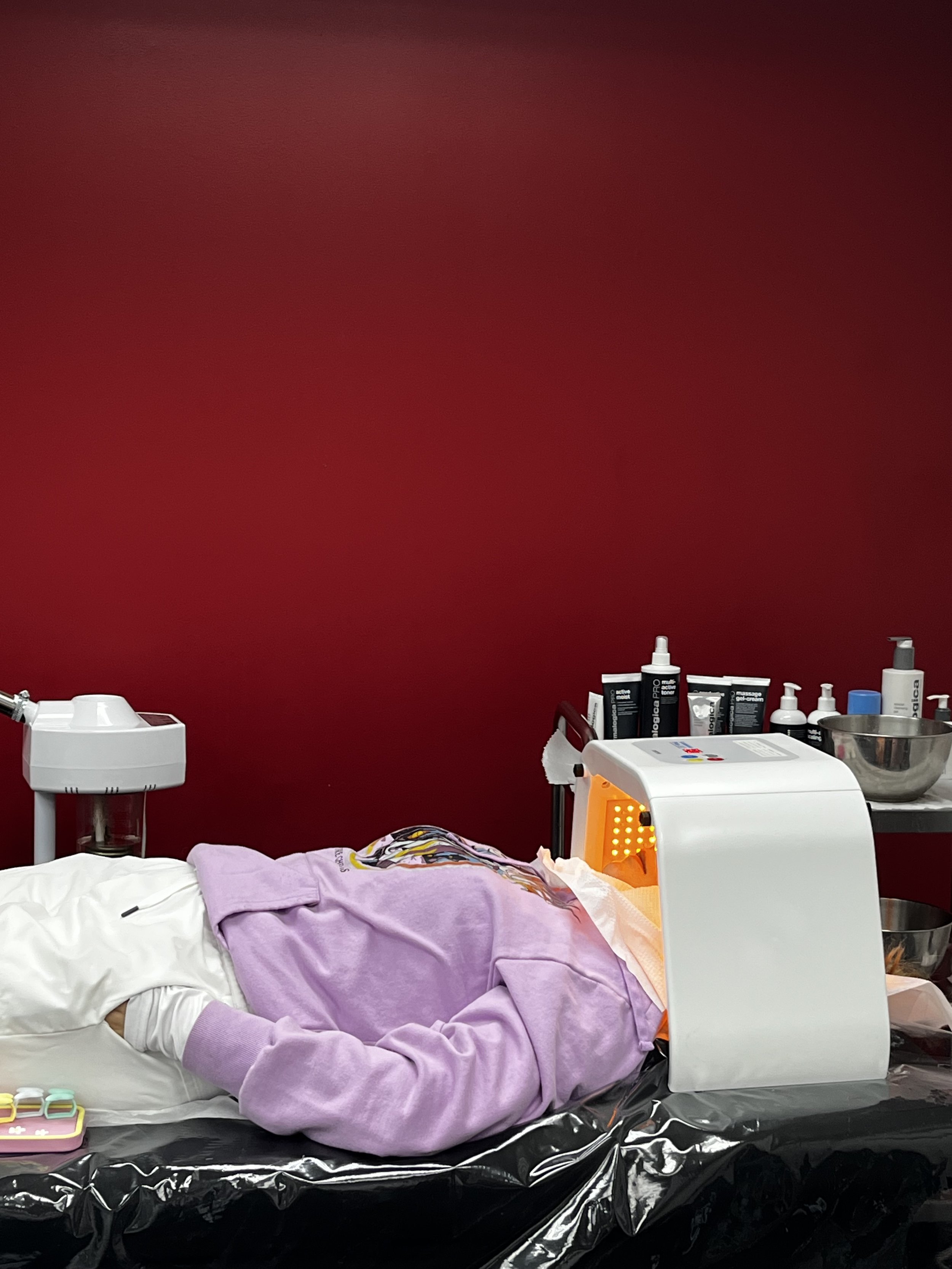Practicing LED light therapy to calm redness and support skin recovery.