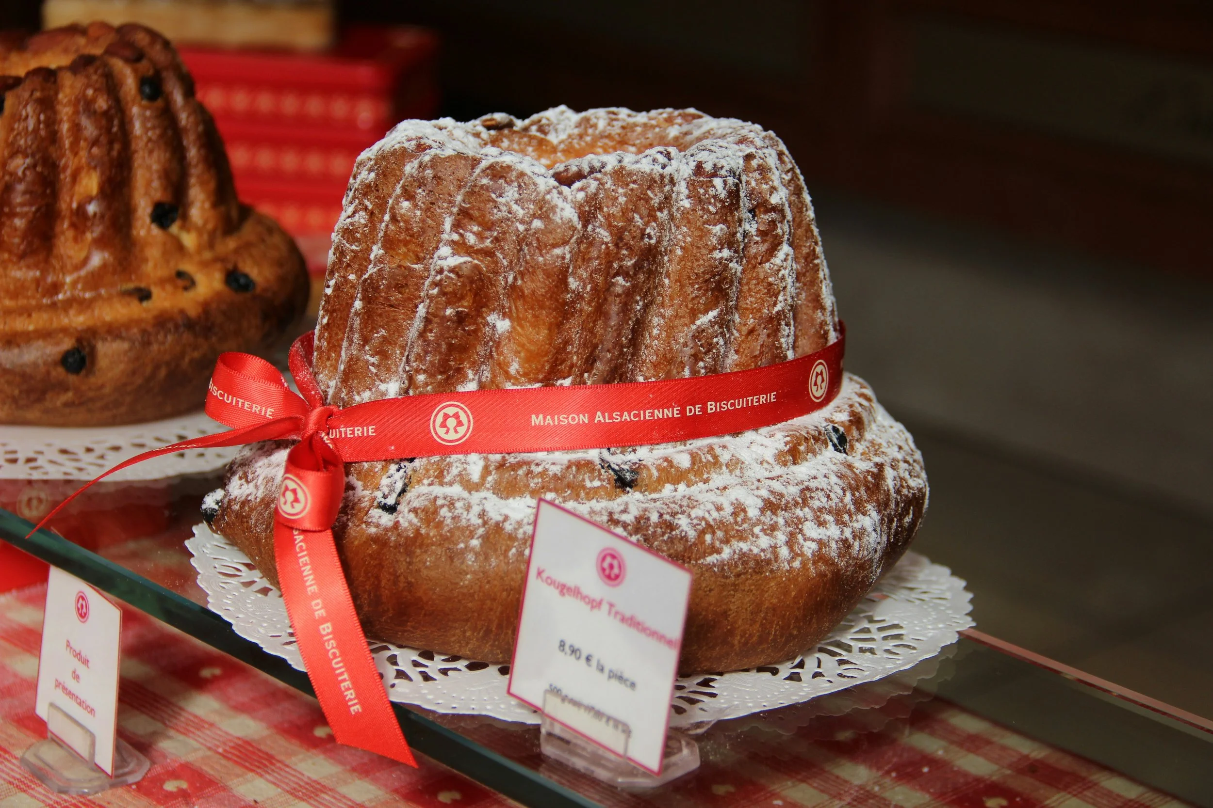 Large kougelhopf cake tied with a red ribbon.