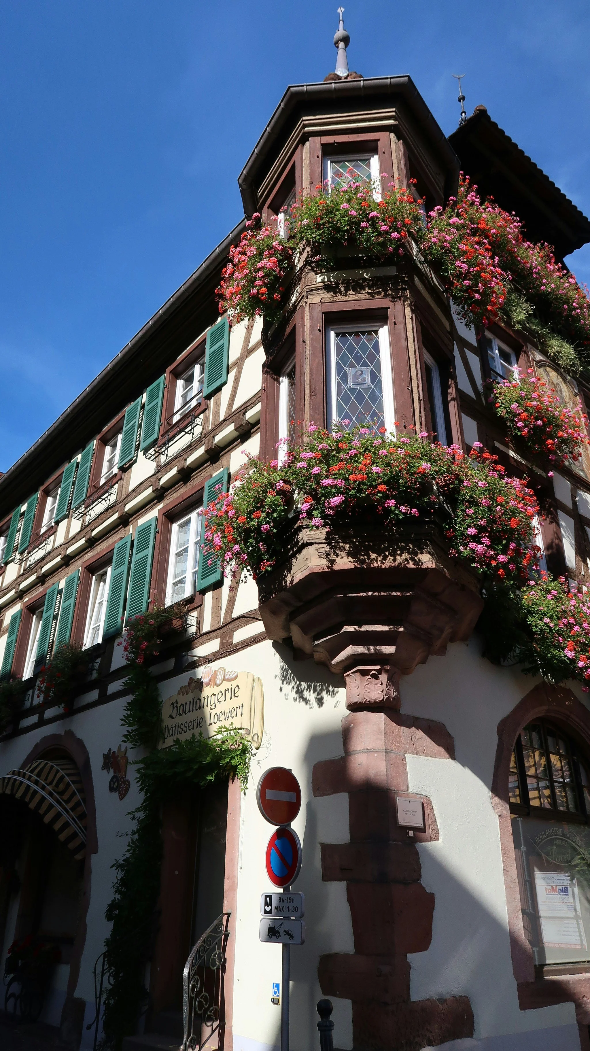 Traditional building decorated with cascading flowers.