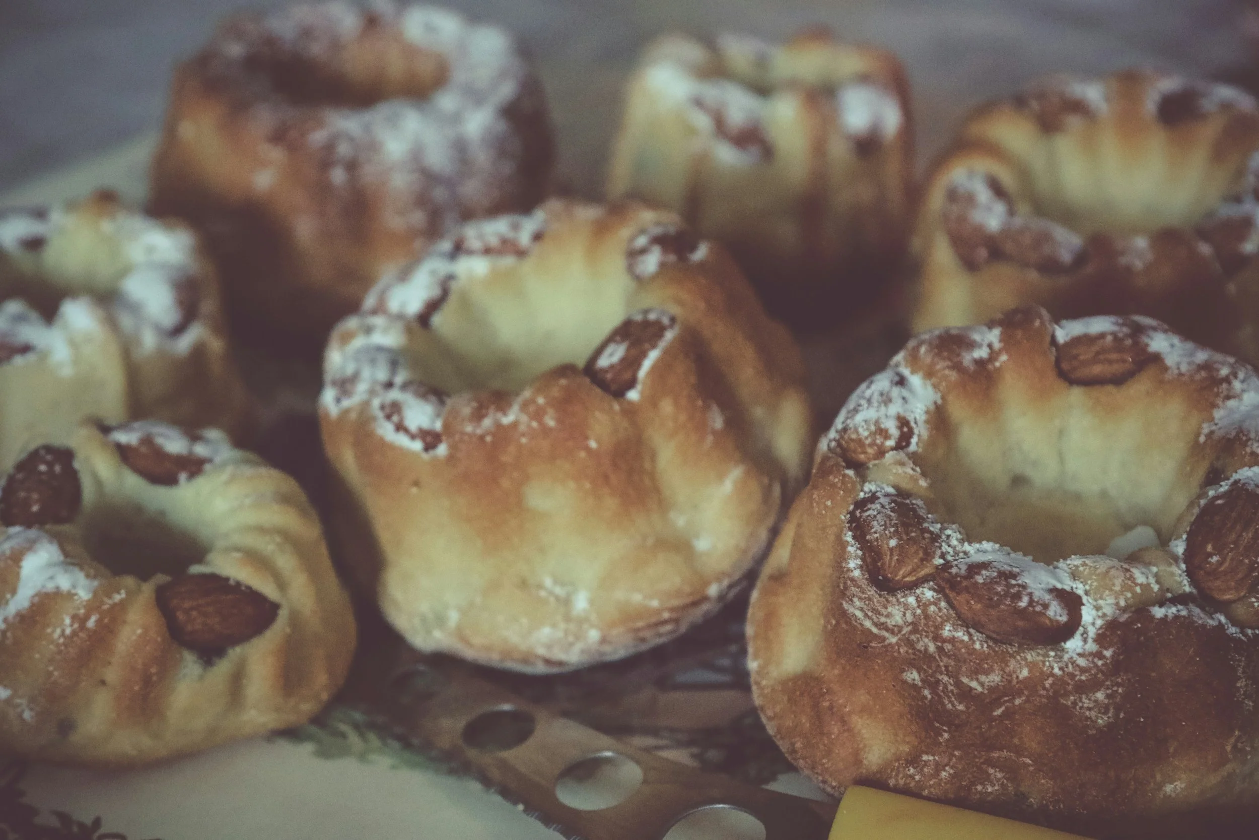 Mini kougelhopf cakes dusted with powdered sugar and almonds.