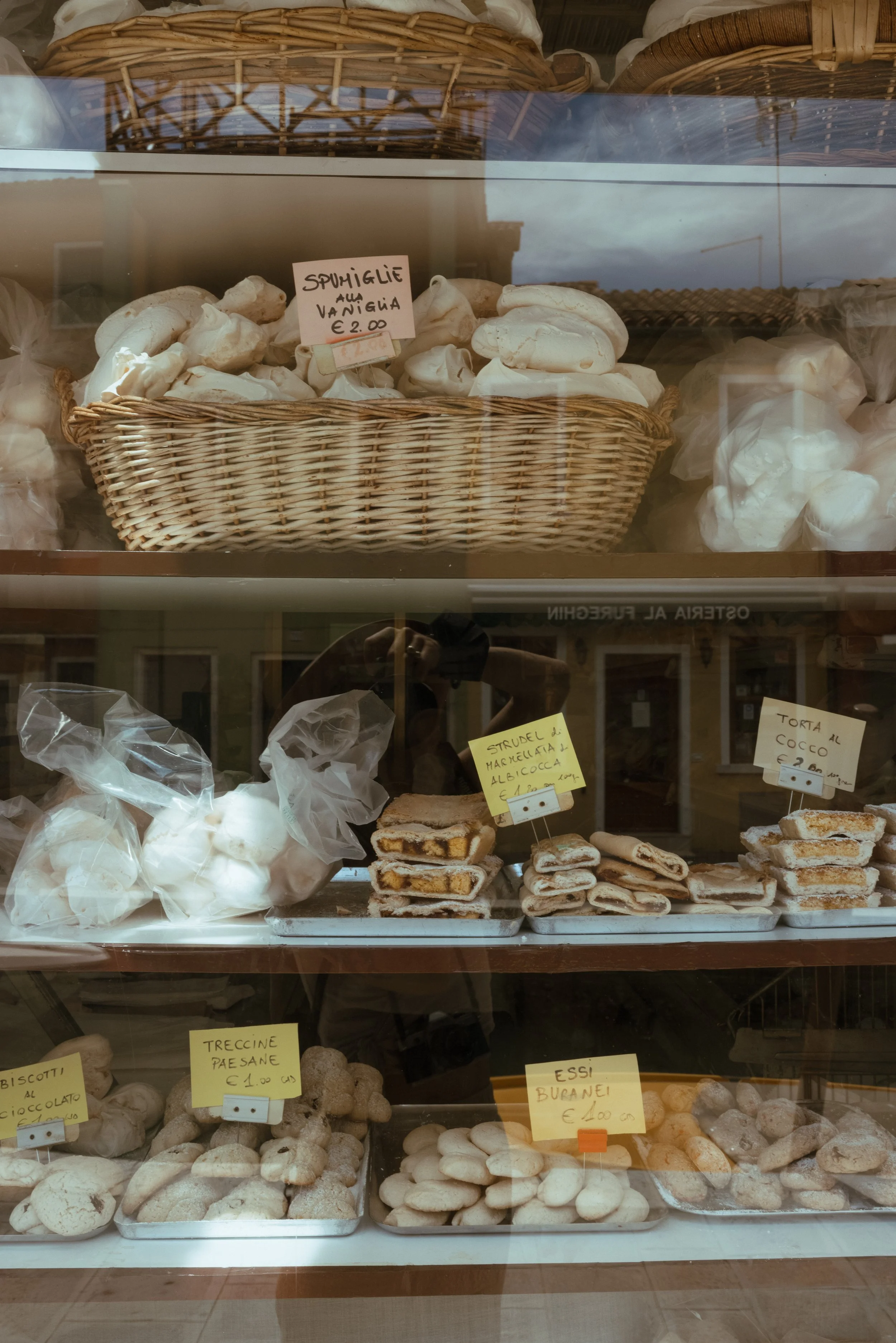 a bakery of goods showcased in a window 
