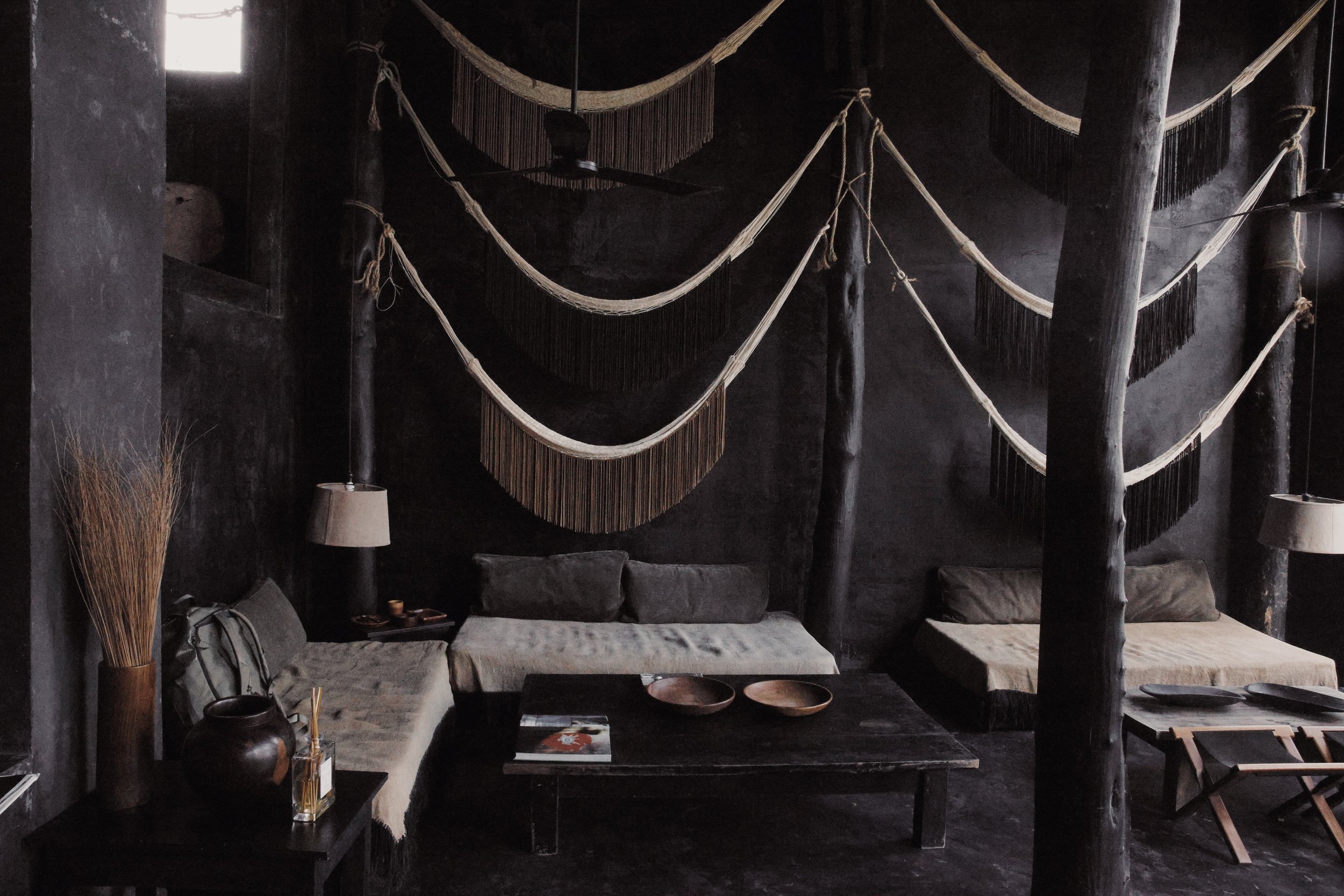 an entryway to an exotic resort with muted and sultry grey and beige tones 