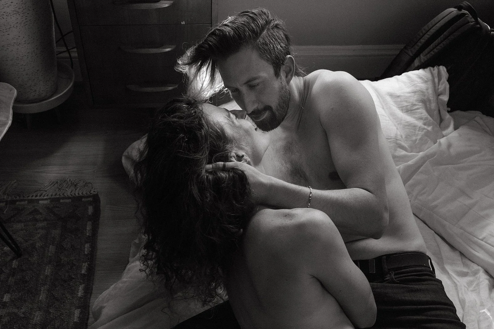 a couple on vacation in Portland waking up. slow lying in bed together