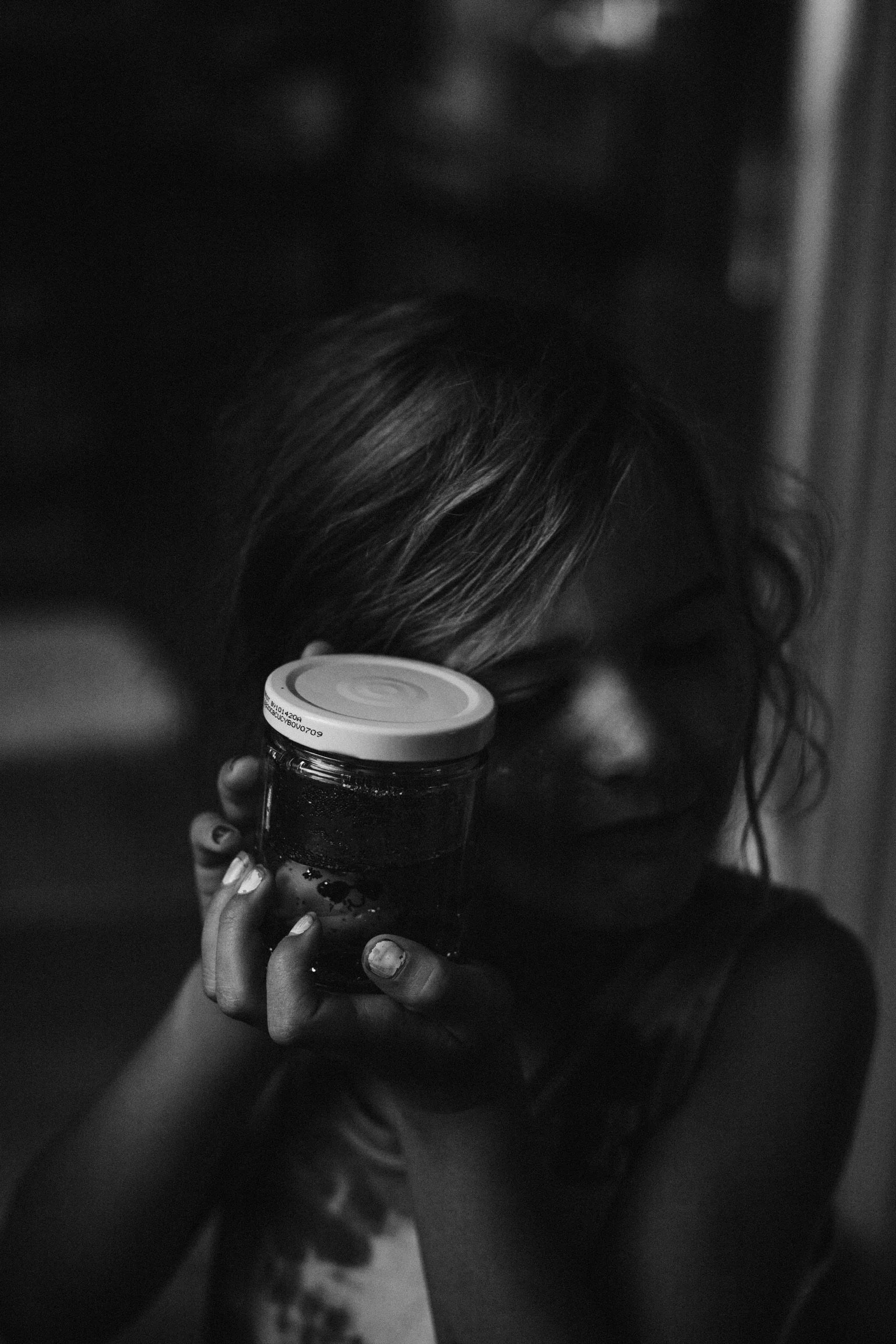 fermenting goods in a jar held by a sweet young child holding it with care