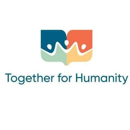 Logo with two stylized hands joining together, one in teal and the other in orange, forming a speech bubble, with the text 'Together for Humanity' underneath.