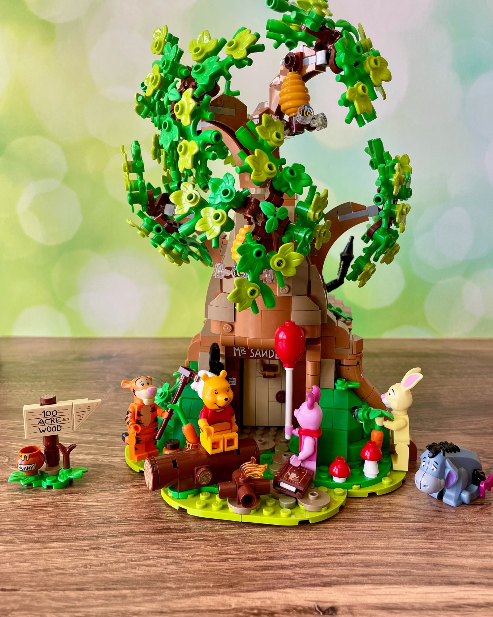 LEGO Winnie the Pooh treehouse with Pooh, Piglet, Tigger, Rabbit, and Eeyore gathered beneath a leafy tree, inspiring imaginative play and storytelling.