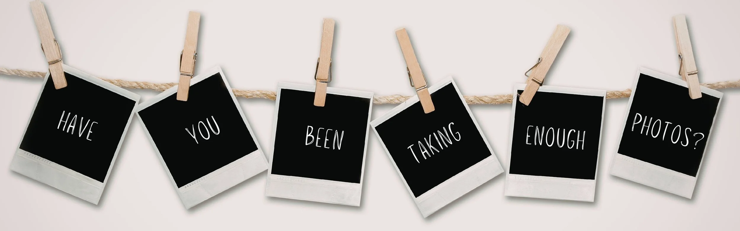 Horizontal banner with Polaroid-style photos hanging on a clothesline, each frame spelling out the phrase Have you been taking enough photos?