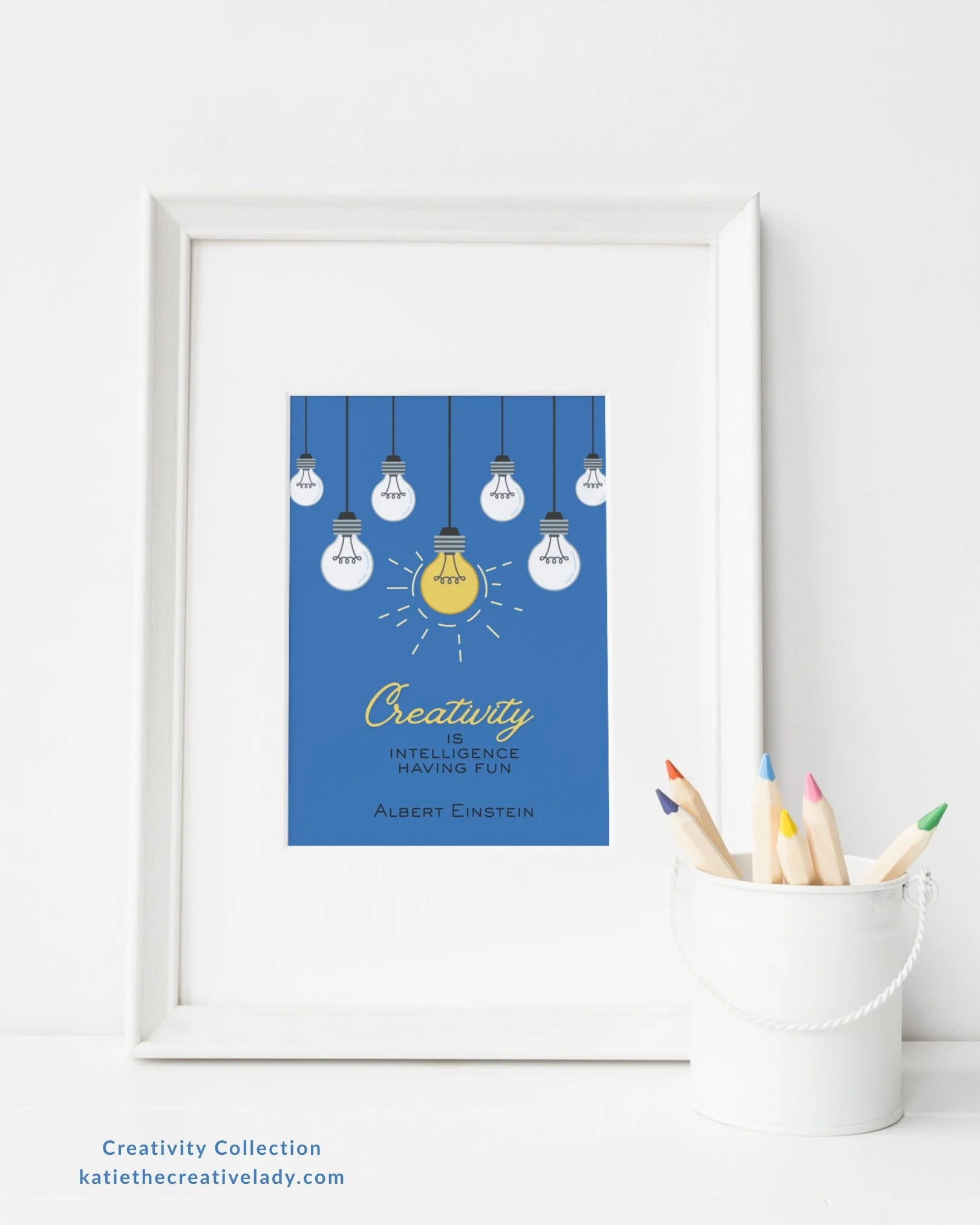 Creativity quote by Albert Einstein in a white frame beside colored pencils on a shelf.