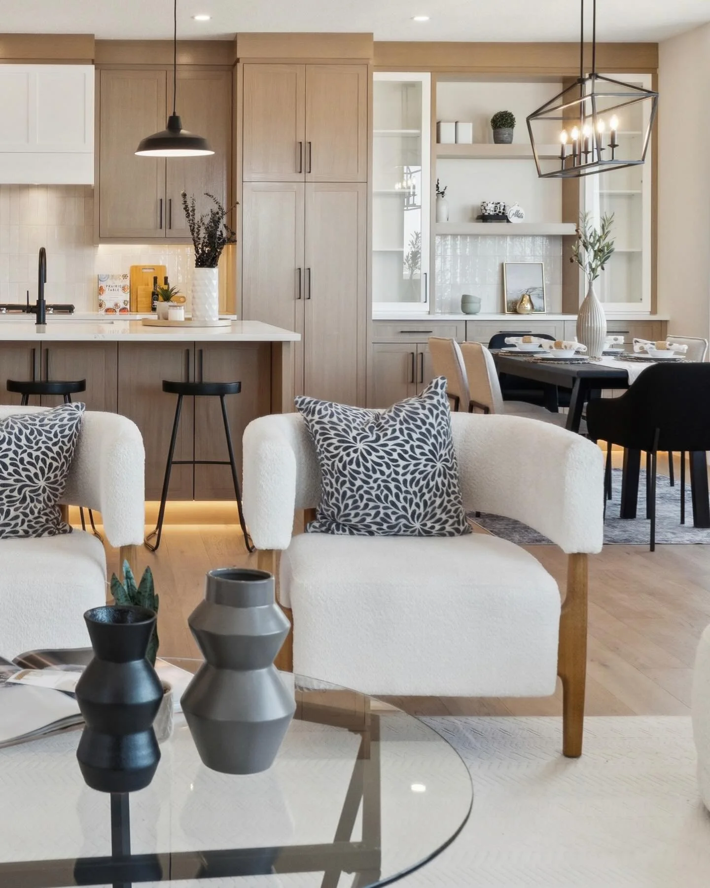 The heart of the home.

From the custom white oak cabinetry and sculptural hood fan to the warm glow of the toe-kick lighting, this kitchen is a masterclass in modern transitional design. We paired organic textures with sharp black accents to create 