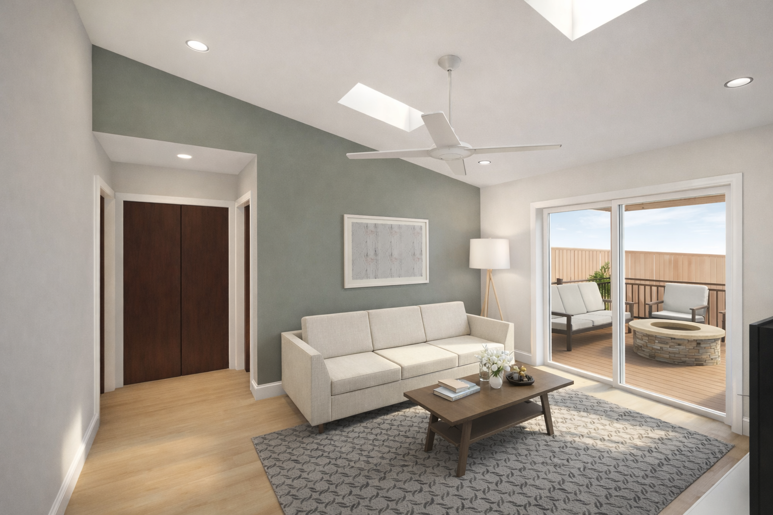 Living room with beige sofa, wooden coffee table, patterned rug, white floor lamp, ceiling fan, skylights, sliding glass door leading to balcony with outdoor furniture.