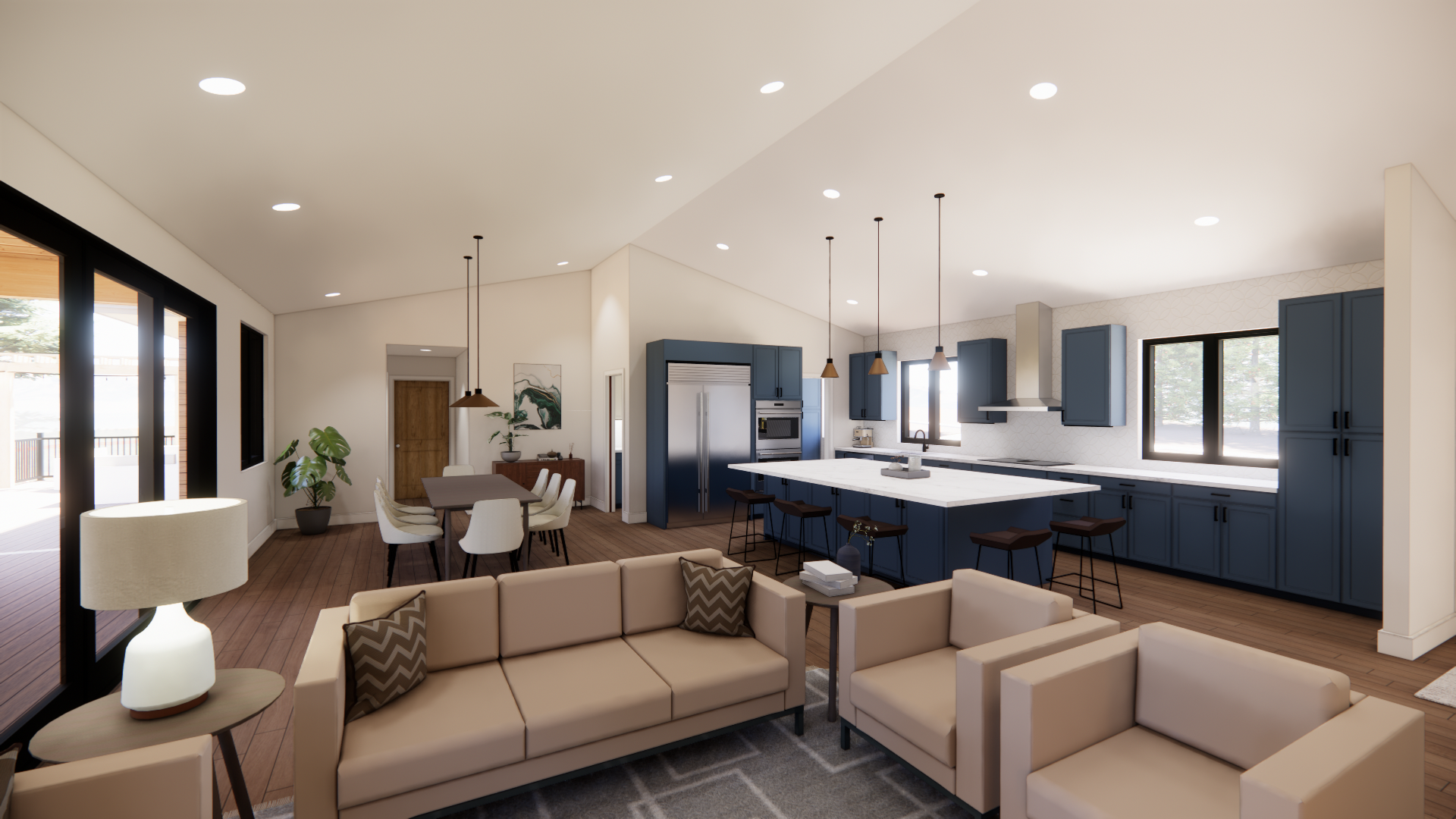 Open-concept kitchen and living area with beige sectional sofa, wooden dining table with white chairs, blue kitchen cabinets, stainless steel refrigerator, and island with bar stools. Large windows and glass doors leading outside.