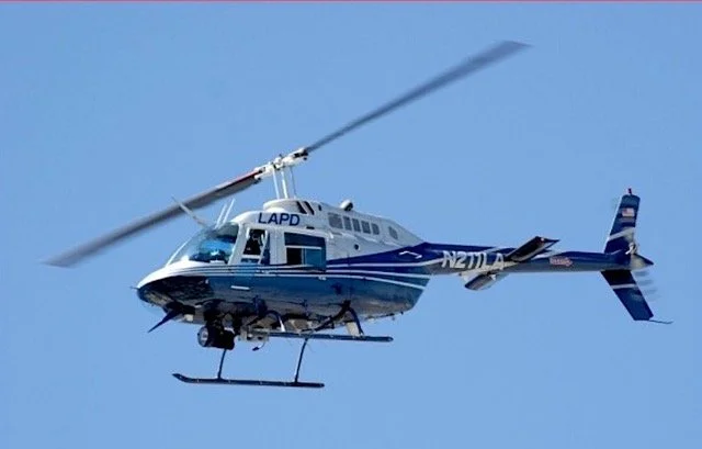 From Orbits Over Los Angeles: A sleek Jet Ranger helicopter and Collin’s “office” for years.