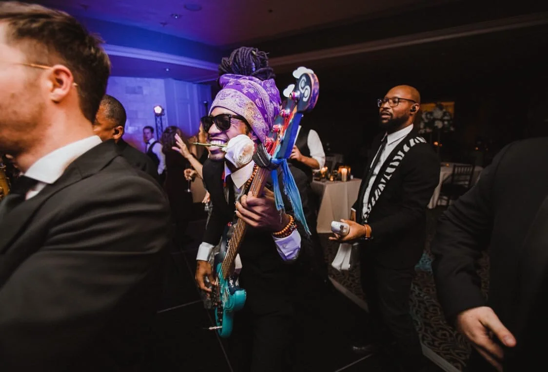  Once the party really gets going, Siah’s signature move of having a flower in his teeth.  Photo by Daniel Colvin Photography 