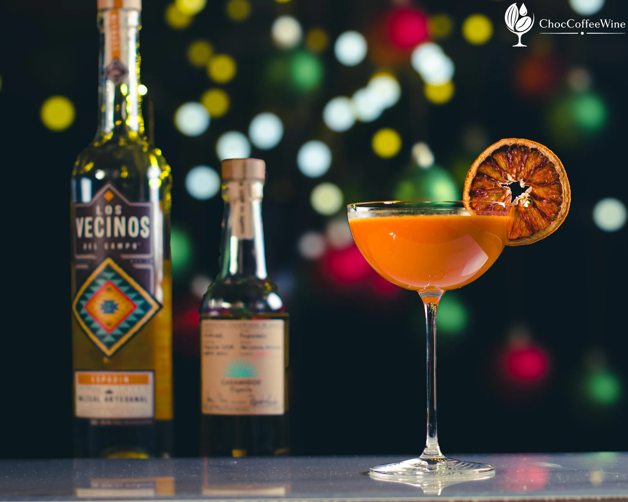 Saffron Sunrise mezcal and reposado tequila sour with egg-white foam and a fried blood-orange garnish
