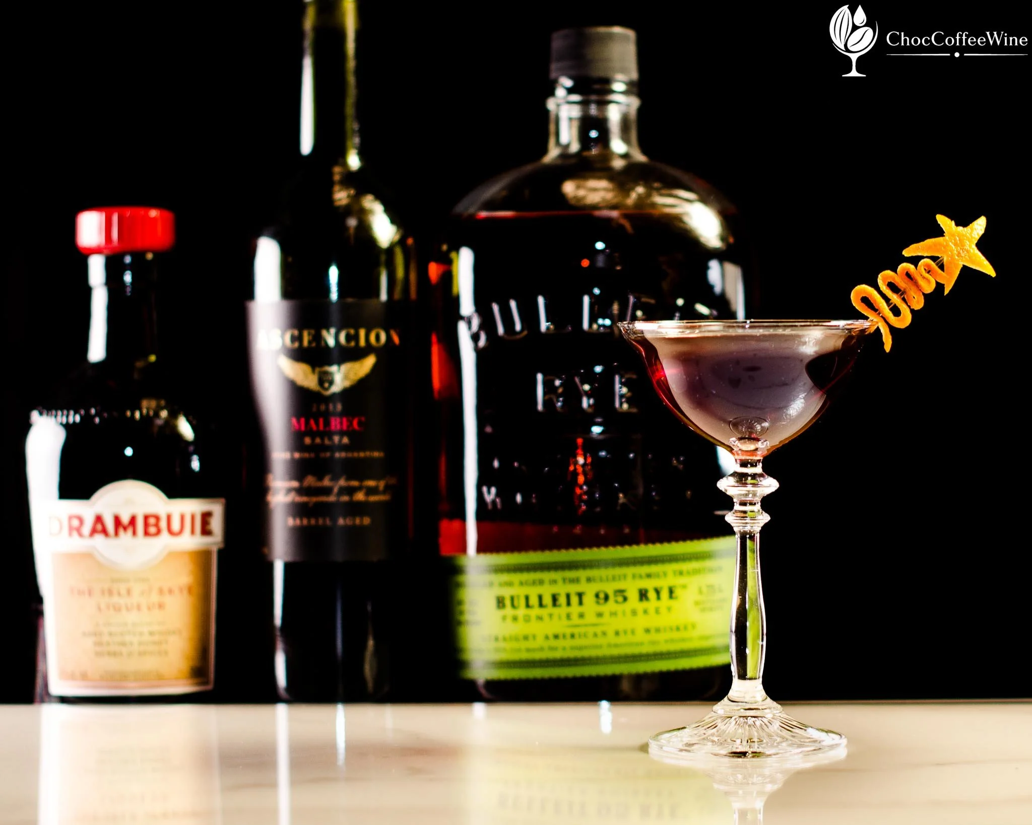 The Giving Tree cocktail made with rye whiskey, red wine, Drambuie and bitters with an orange peel garnish