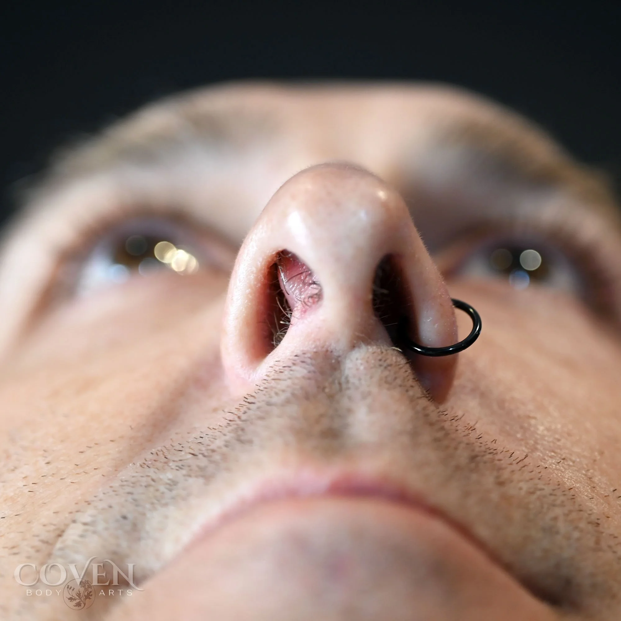 a man with a very deviated septum right before having it pierced by Dee at Coven Body Arts, a professional body piercing studio in Calgary, Alberta, Canada.
A man with a deviated septum prior to having it pierced.
A closeup of a mans deviated septum 