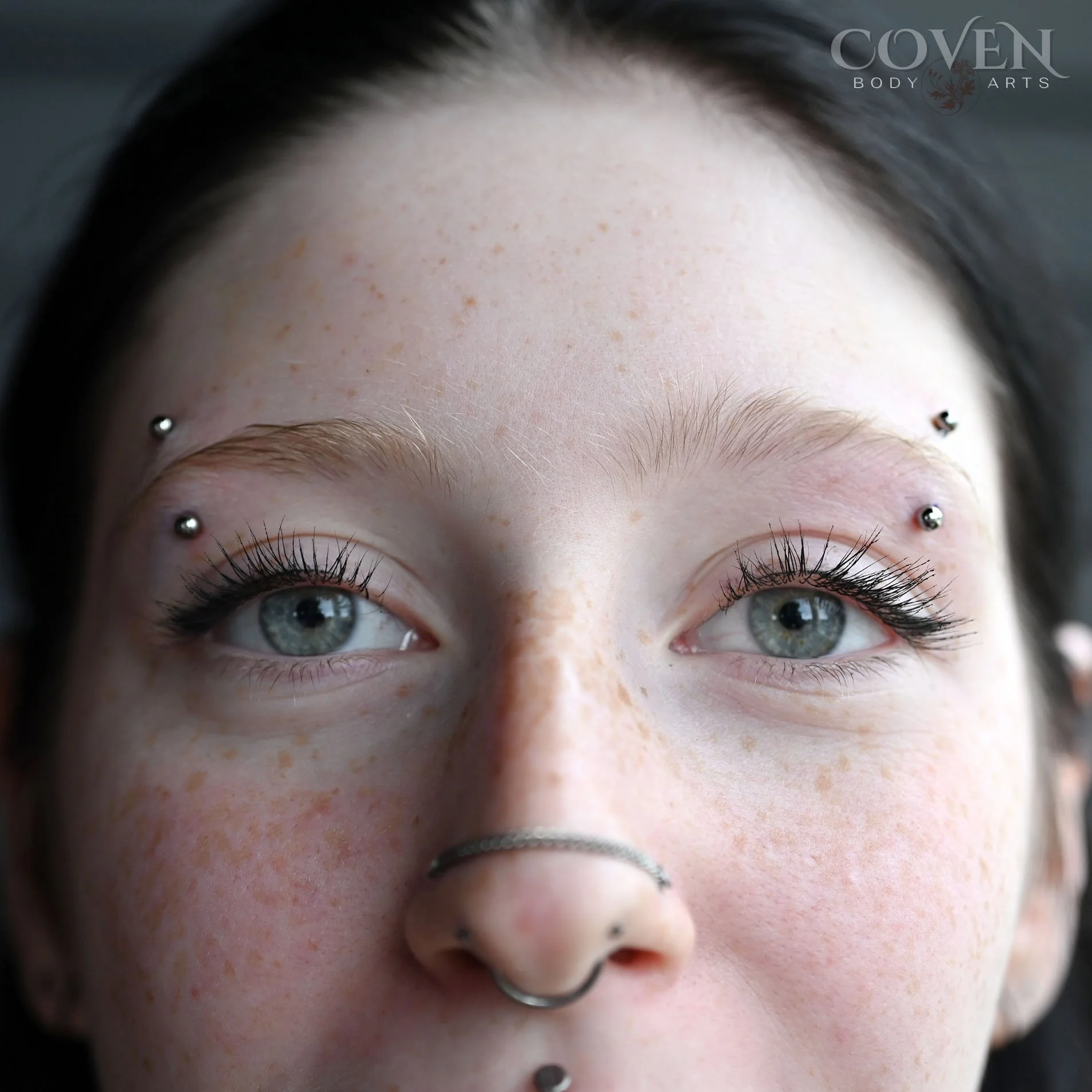 paired eyebrow piercings done on a girl in calgary at a professional body piercing studio called coven body arts. eyebrow piercings on a girl done with implant grade titanium curved barbells. matching eyebrow piercings, eyebrow piercings, piercings o
