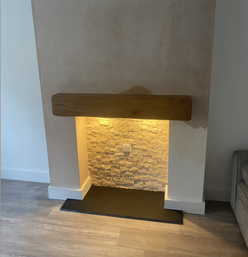 Fireplace with oak mantle and tiled based