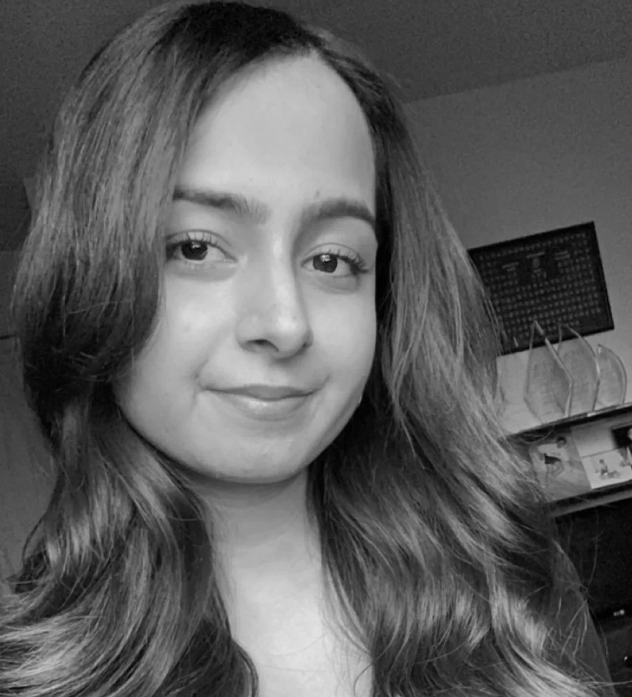 Female therapist with long brown hair looking at the camera