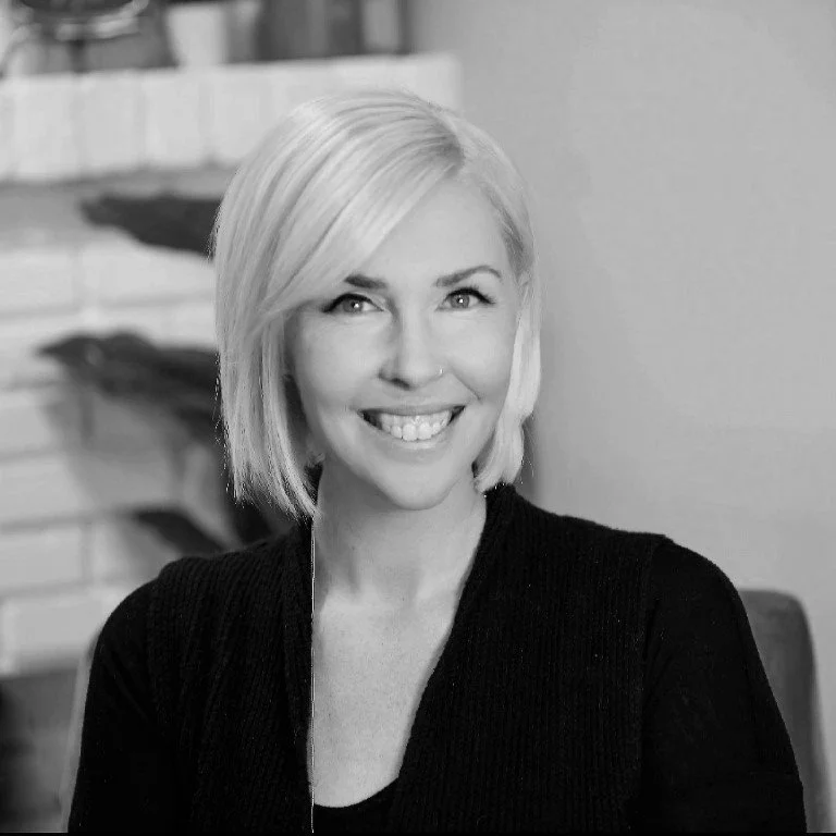 Female therapist with blonde hair smiling at the camera