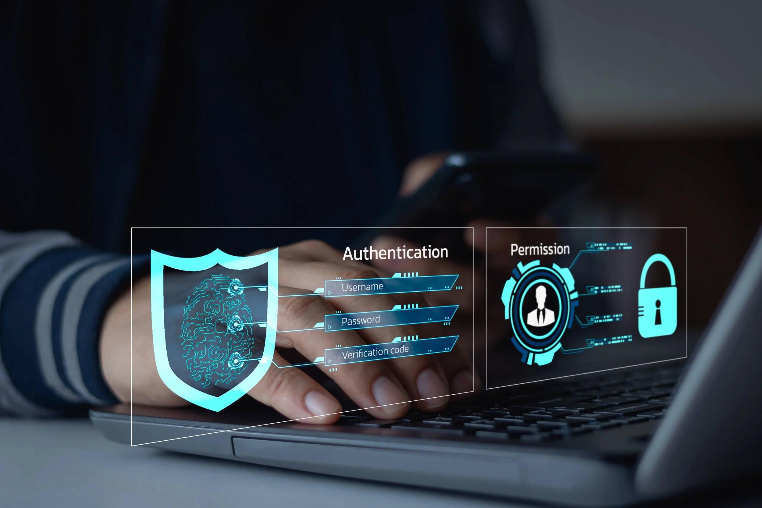 Person using a laptop with digital security graphics on the screen, including a shield with a circuit pattern, and icons for authentication and permission, indicating cybersecurity or digital identity verification.