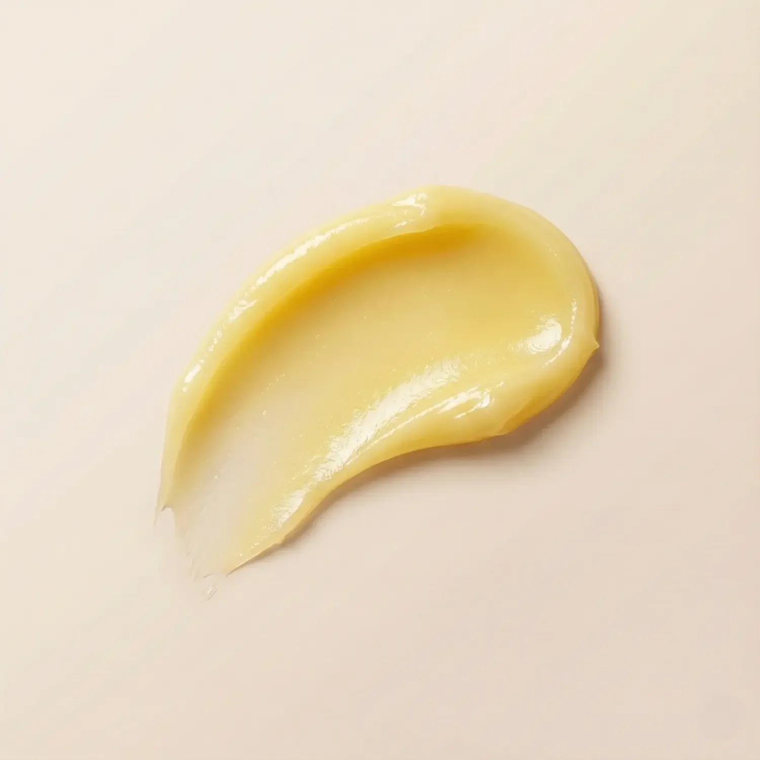 coconut-lip-balm-smear-on-pastel-beige-background.webp
