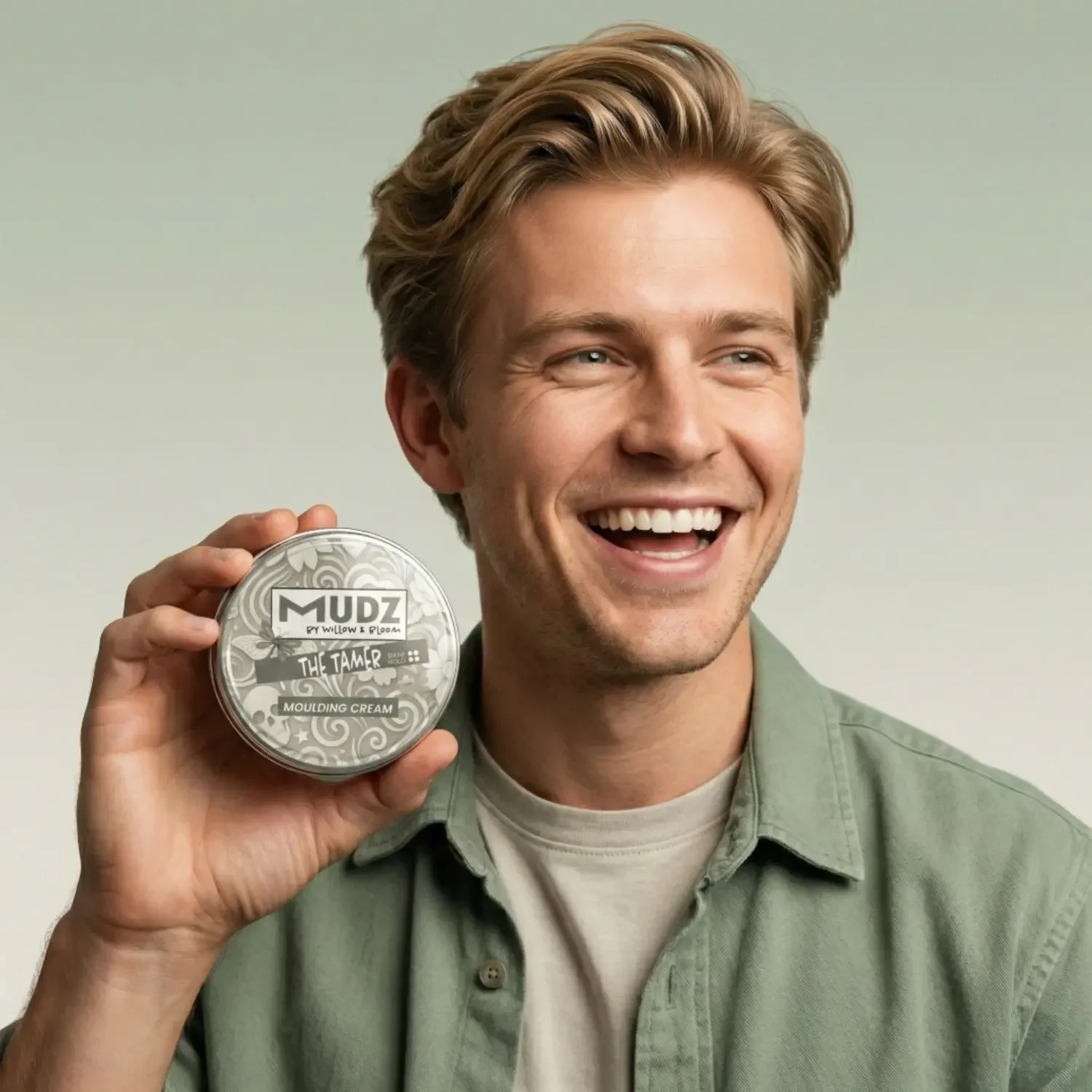 blonde-haired-model-smiling-and-holding-a-hair-moulding-cream.webp