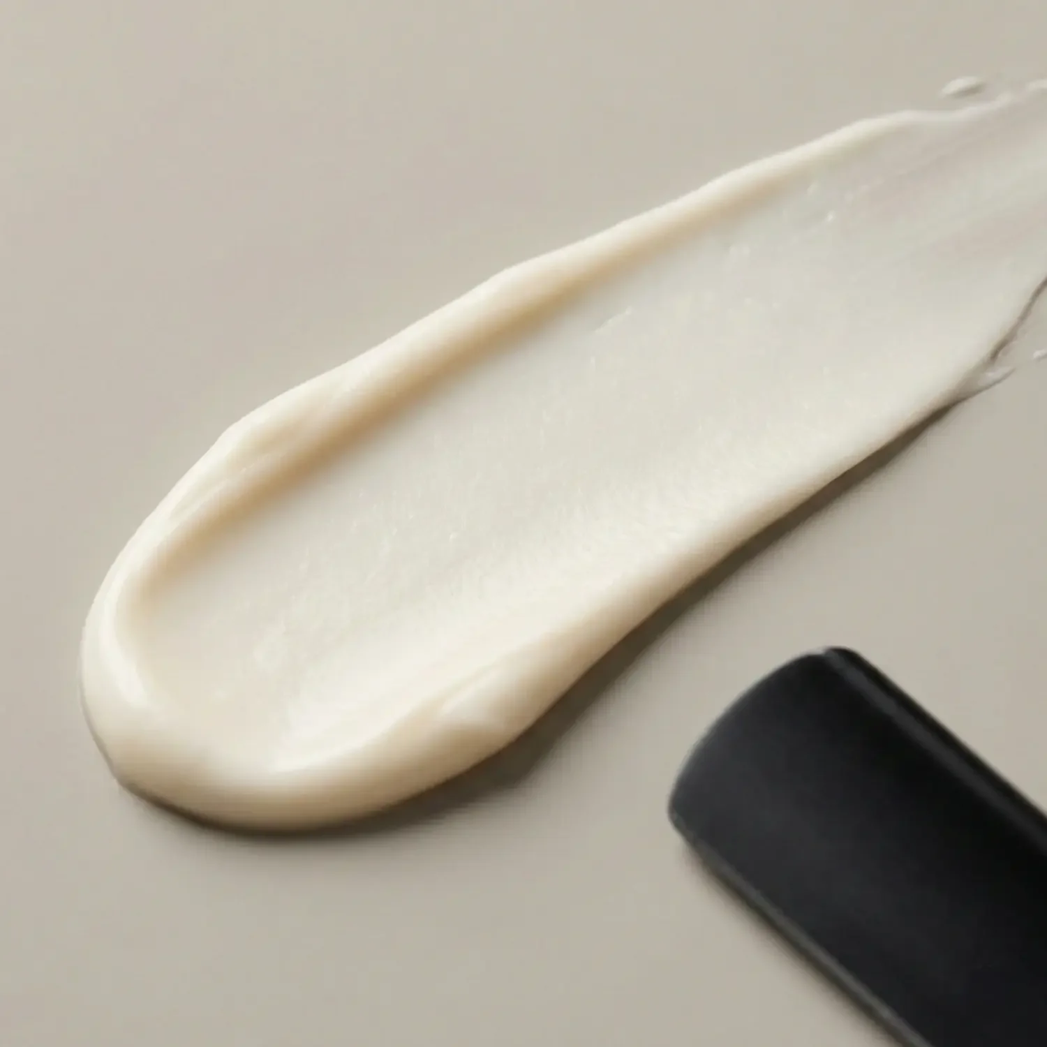 smudge-of-hair-cream-on-beige-background.webp