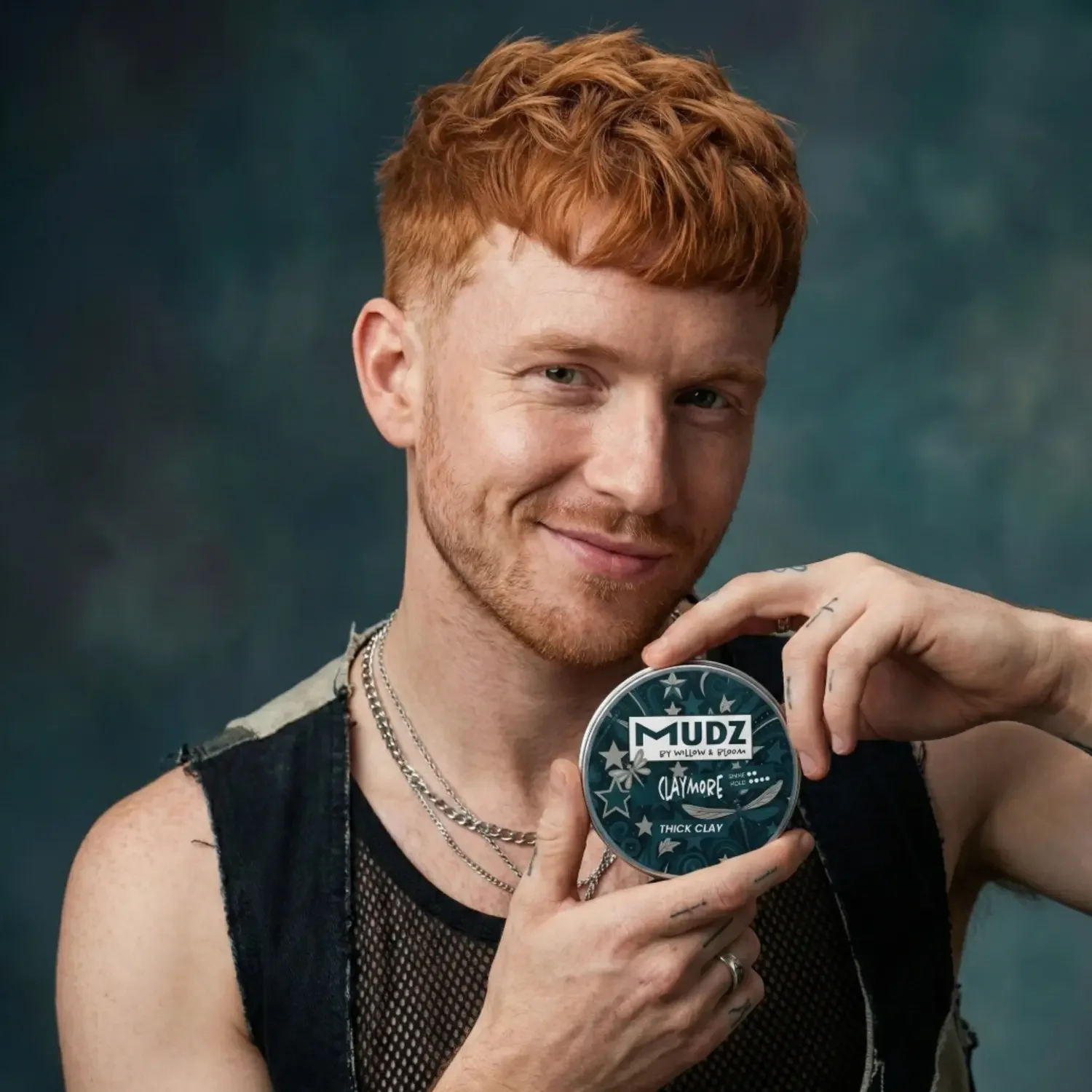 red-haired-model-holding-a-hair-product.webp