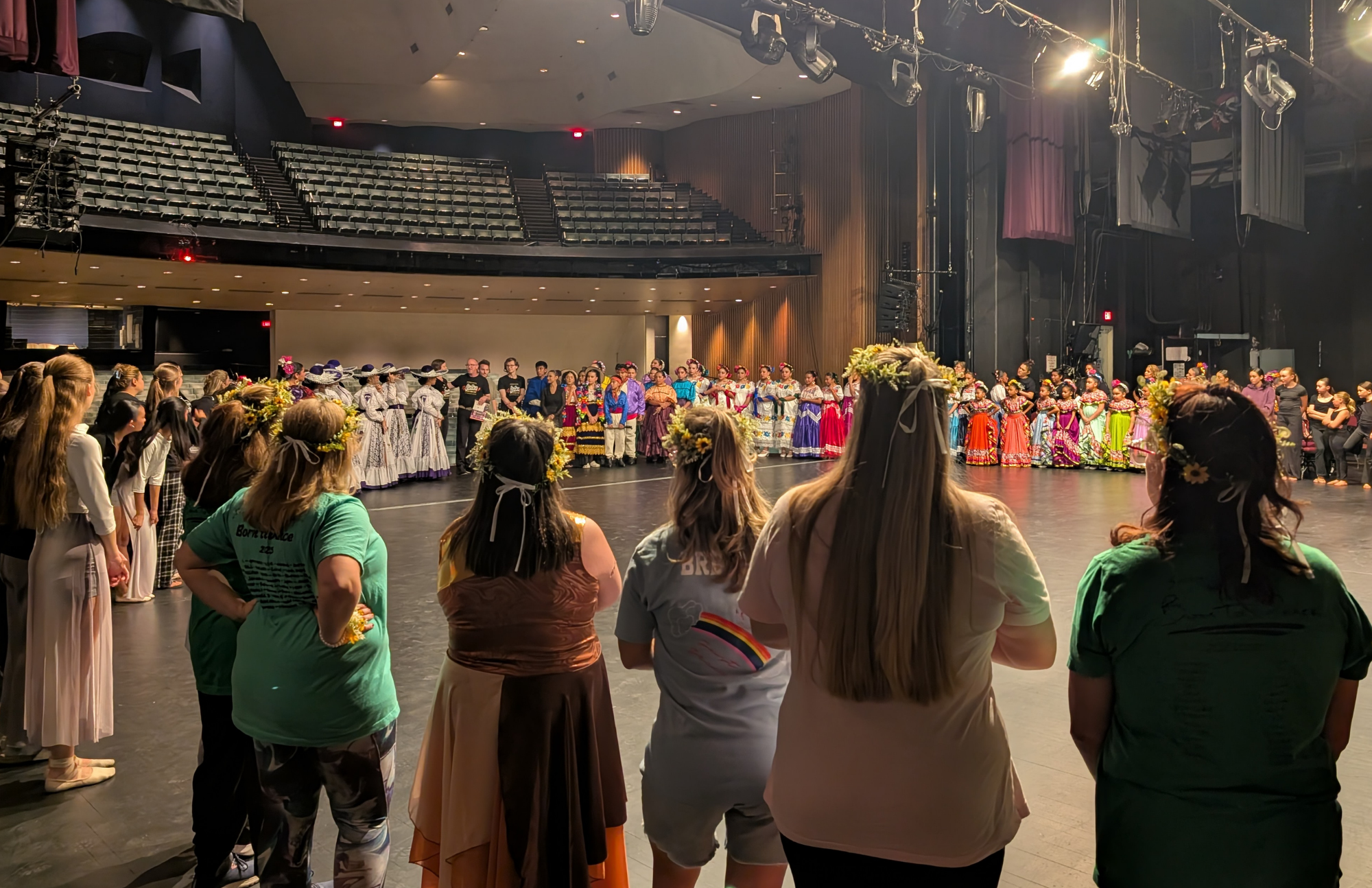 The dancers on stage with the other performers at a pre-show meeting.