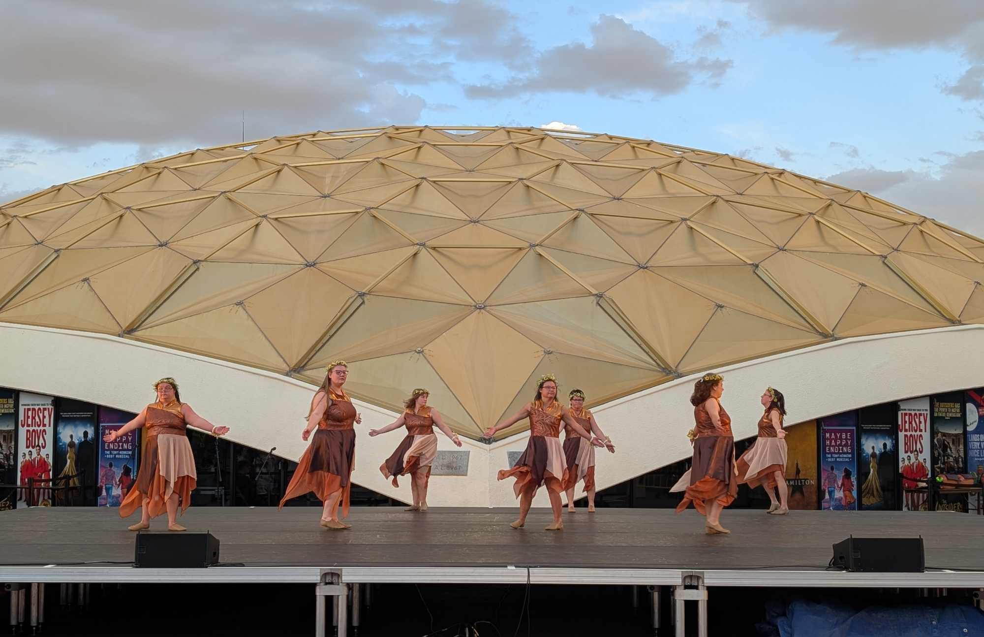 The dancers on stage in front of the gold Pioneer Center dome.