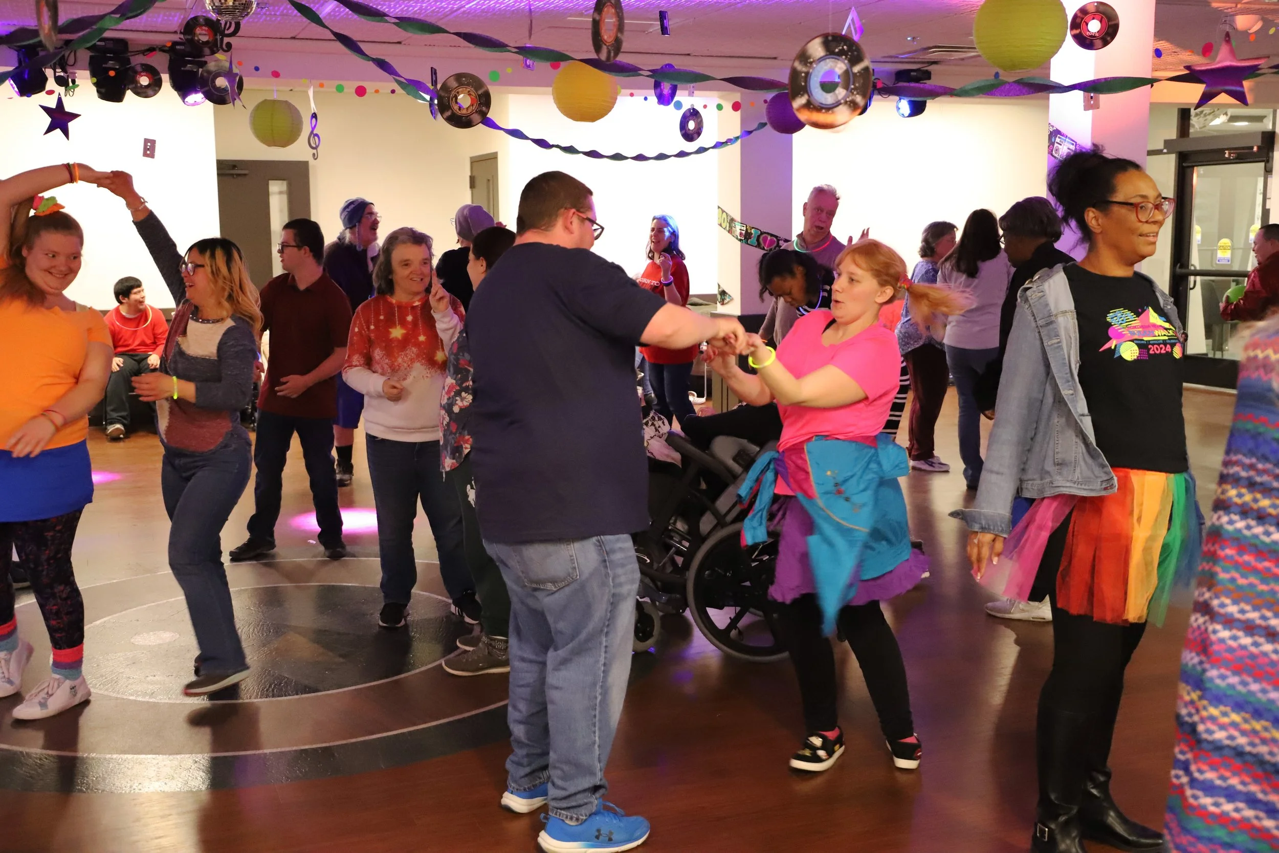 Group of people dancing at NMTS community dance event.