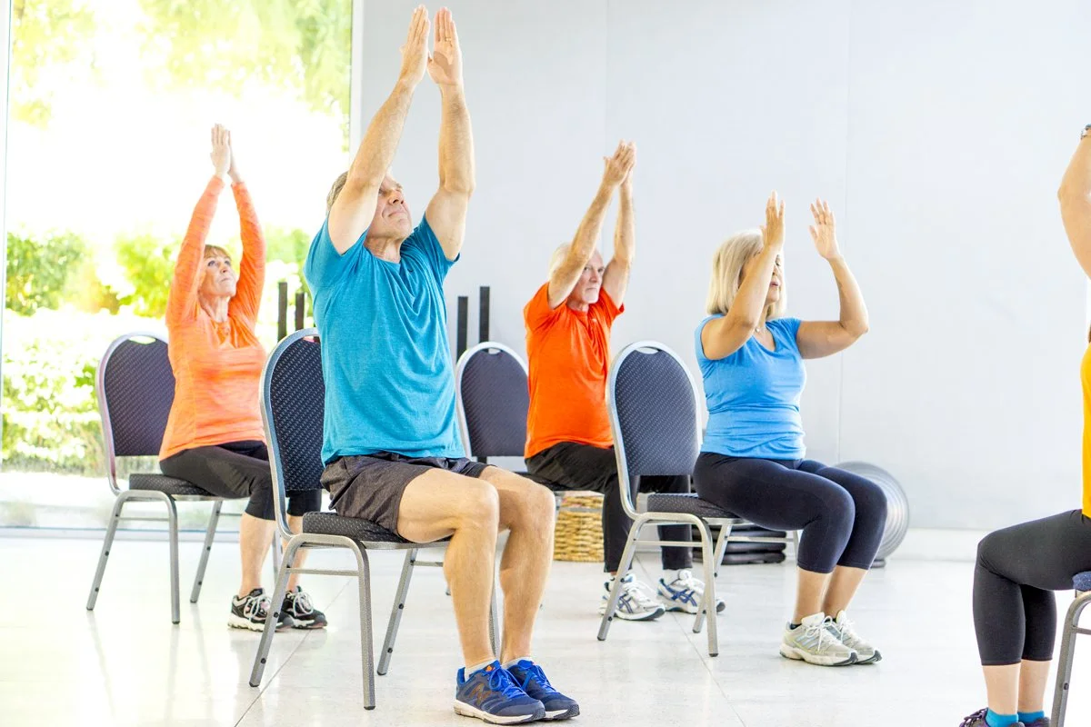 Group of older adults participating in accessible fitness class.