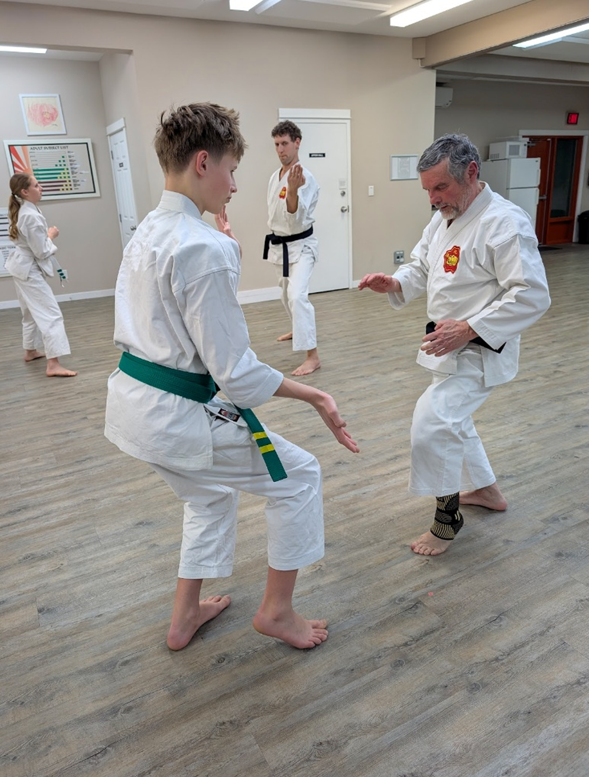 (L to R) Kiara, Aidyn and Aron Zuidhof practice with Chief Instructor Jean-Luc Desgroseilliers (photo credit Scoop staff)