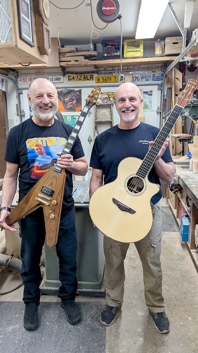 John's former woodwork teacher, Dan Zaklan (L) with John's first guitar, and John with his 1000th guitar