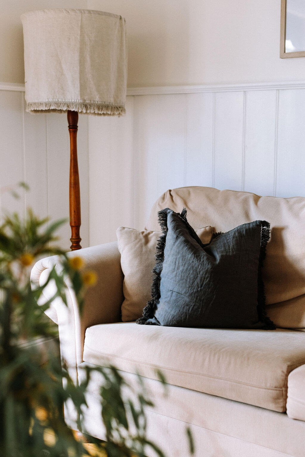 The Inn Beechworth, Luxury Accommodation - Kelly House. Living room with beige sofa, dark pillow, floor lamp, and indoor plant