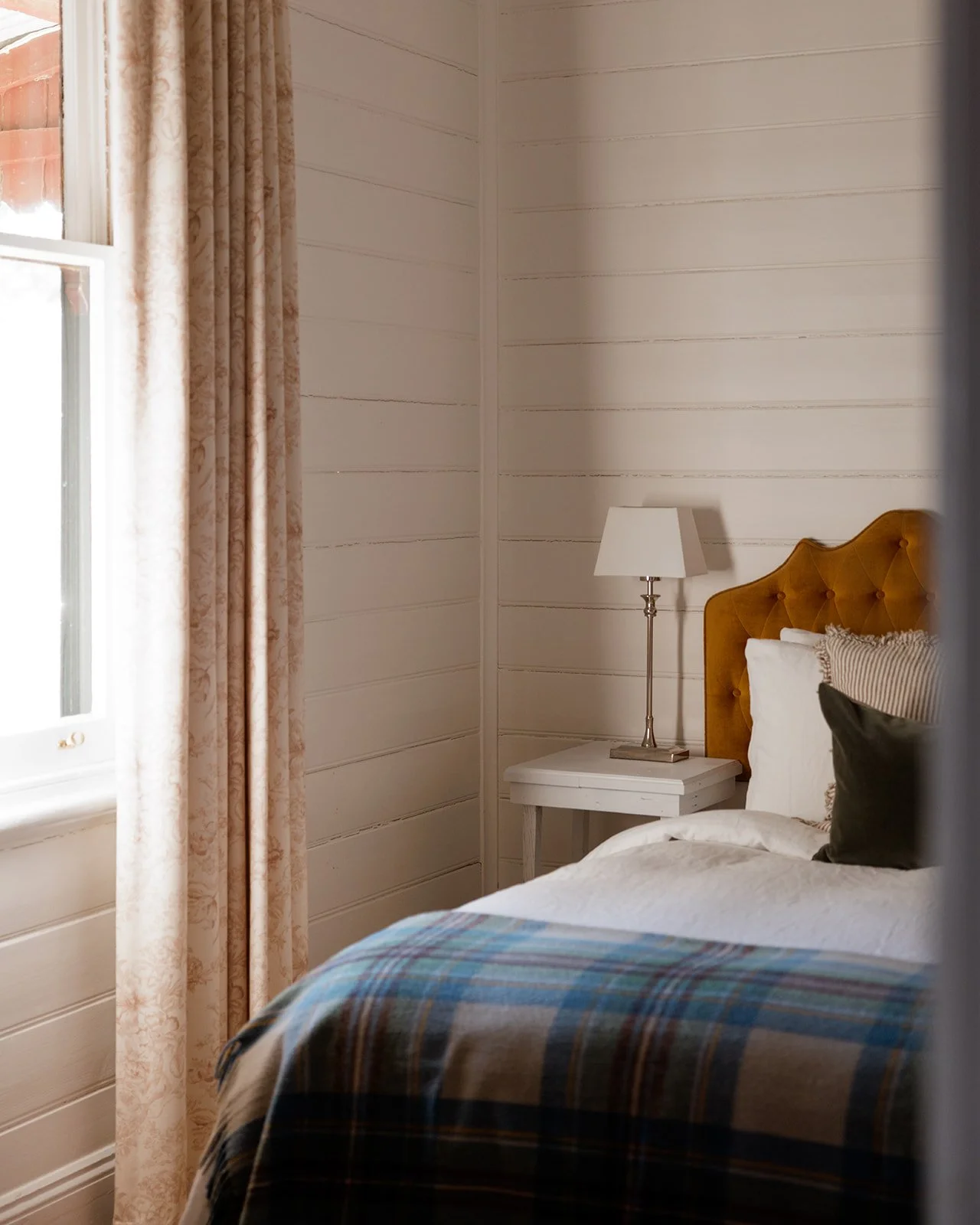 Bedroom Two of Kelly House is decorated in beautiful yellow and green tones.  