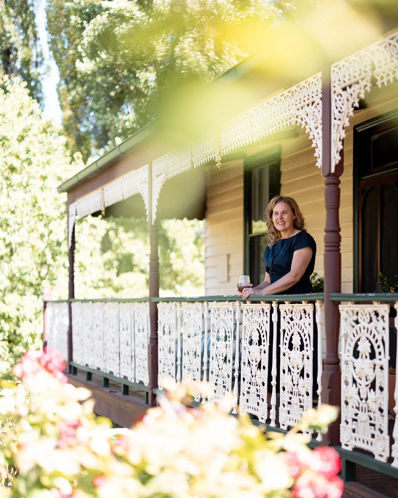 Lee standing on verandah of Kelly House.
