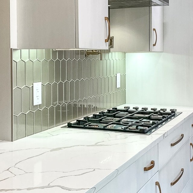 Unveil sophistication in your home with our latest kitchen remodel. White shaker cabinets, marble-patterned countertops, and a unique hexagon tile backsplash define this space. 

#KitchenGoals #RemodelSuccess #DesignInspiration #ChicInteriors #design